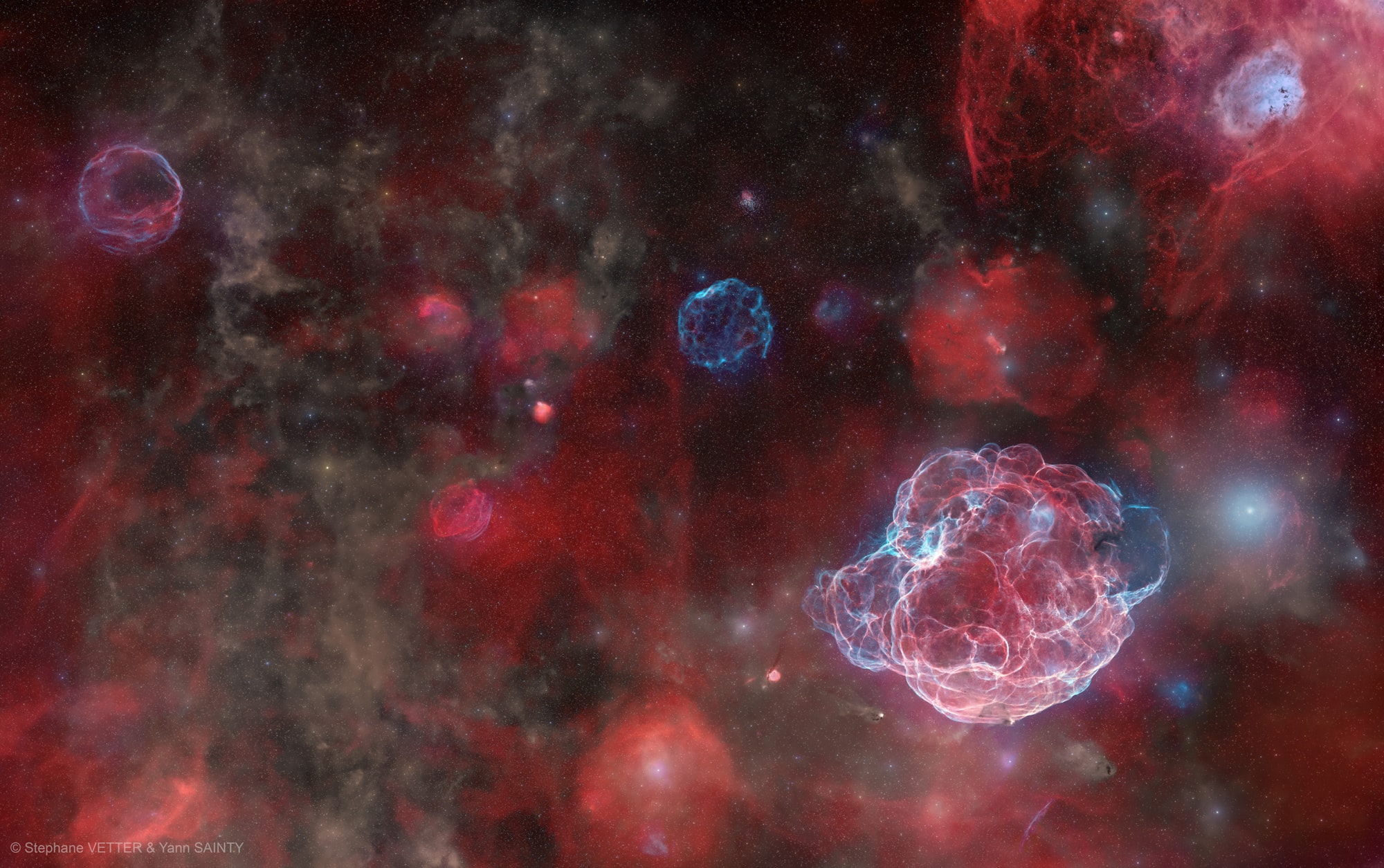 The ghosts of five supernovas haunt this extraordinary image.   It was acquired at Oukaïmeden Observatory in Morocco with approximately 200 hours of observations and shows a large patch of the sky, equivalent to the area of one thousand full moons tiled together, in the constellation of Auriga (the charioteer).   From left to right, the five supernova remnants visible across the field are G181.1+9.5, G182.4+4.3, G179.0+2.6, G180.0−1.7 (Sh2-240, the Spaghetti Nebula), and G178.2−4.2.   They are highlighted in the annotated image, together with open cluster M37 and the Tadpole Nebula.   As each explosion expanded into space, it created a growing shell of shocked gas and delicate filamentary structures shown in red (hydrogen) and blue (oxygen), respectively.    These ancient stellar explosions happened independently; they are at various distances up to about several thousands of light-years away from Earth and have estimated ages up to tens of thousands of years old.   Early humans may have witnessed them as bright new stars, fading over weeks or months.     APOD's email for image submissions has changed. Please see: APOD Submissions.    APOD's main NASA site is moving : From apod.nasa.gov to science.nasa.gov/apod