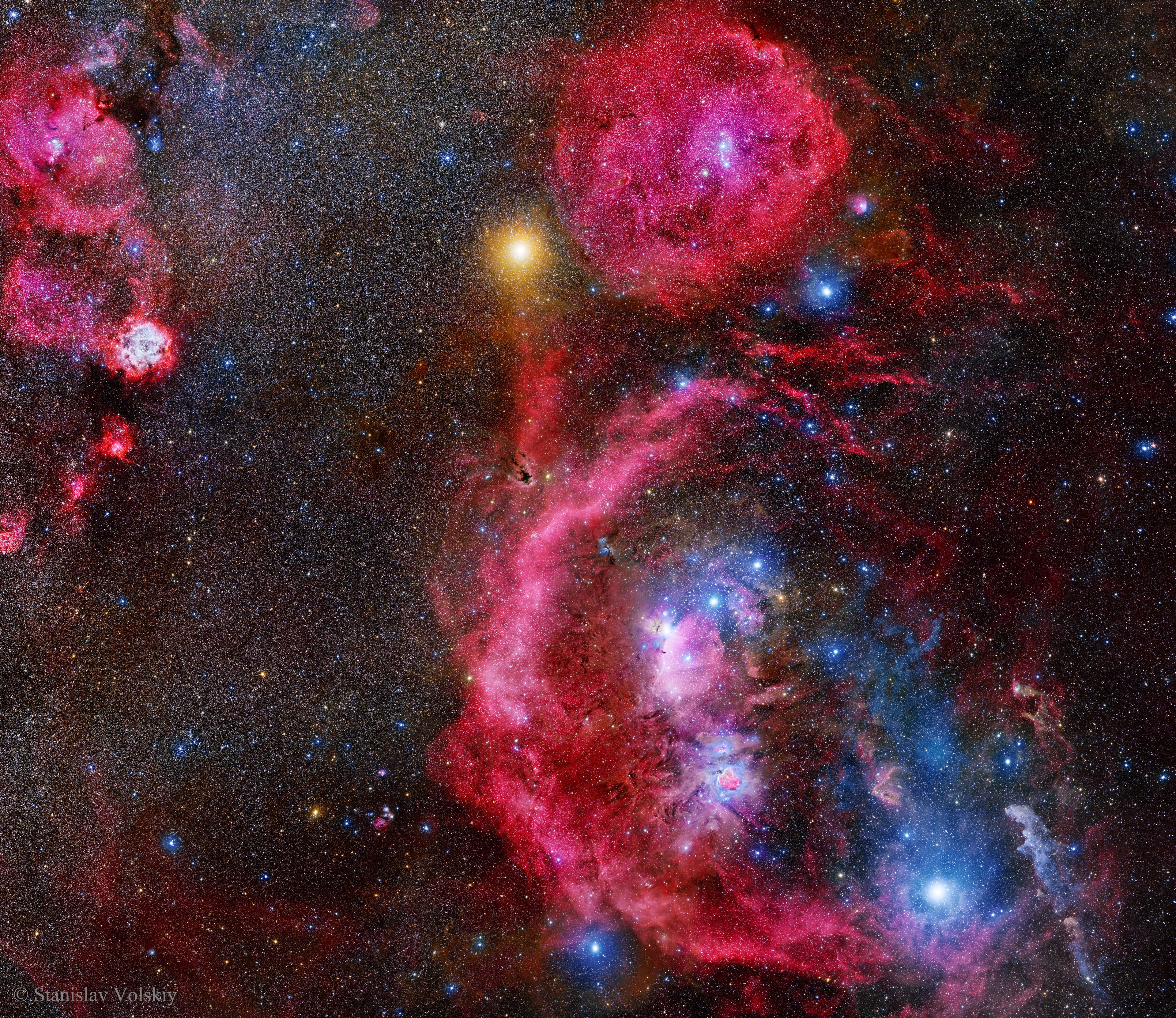 The constellation of Orion is much more than three stars in a row. It is a direction in space that is rich with impressive nebulas. To better appreciate this well-known swath of sky, an extremely long exposure was taken over many clear nights in 2013 and 2014. After 212 hours of camera time and an additional year of processing, the featured 1400-exposure collage spanning over 40 times the angular diameter of the Moon emerged. Of the many interesting details that have become visible, one that particularly draws the eye is Barnard's Loop, the bright red circular filament arcing down from the middle. The Rosette Nebula is not the giant red nebula near the top of the image -- that is a larger but lesser known nebula known as Lambda Orionis. The Rosette Nebula is visible, though: it is the red and white nebula on the upper left. The bright orange star just above the frame center is Betelgeuse, while the bright blue star on the lower right is Rigel. Other famous nebulas visible include the Witch Head Nebula, the Flame Nebula, the Fox Fur Nebula, and, if you know just where to look, the comparatively small Horsehead Nebula. About those famous three stars that cross the belt of Orion the Hunter -- in this busy frame they can be hard to locate, but a discerning eye will find them just below and to the right of the image center.