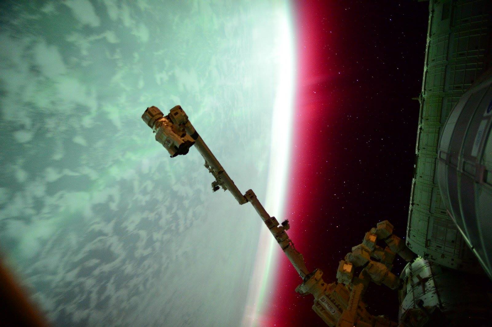 What bizarre alien planet is this? It's planet Earth of course, seen from the International Space Station through the shimmering glow of aurorae. About 400 kilometers (250 miles) above Earth, the orbiting station is itself within the upper realm of the auroral displays. Aurorae have the signature colors of excited molecules and atoms at the low densities found at extreme altitudes. Emission from atomic oxygen dominates this view. The eerie glow is green at lower altitudes, but a rarer reddish band extends above the space station's horizon. Also visible from the planet's surface, this auroral display began during a geomagnetic storm. The storm was triggered after a coronal mass ejection impacted Earth's magnetosphere in June of 2015.