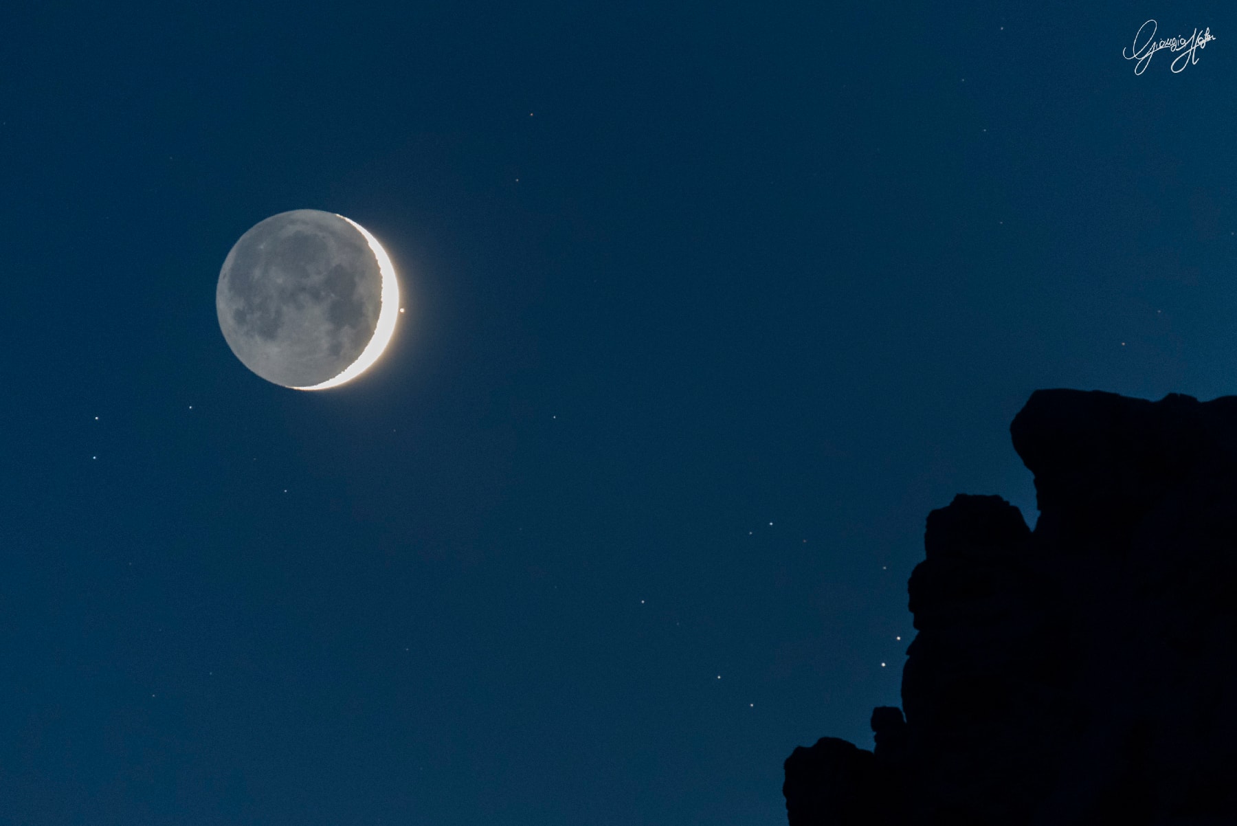Aldebaran, eye of Taurus the Bull, and a young crescent Moon shared an early evening sky last Friday. The lovely celestial pairing could be enjoyed around planet Earth, but from some locations the Moon was even seen to pass in front of Aldebaran, a dramatic lunar occultation of the familiar bright star. Taken at nightfall on April 28, this skyscape captures Aldebaran shortly after it emerged from behind the bright lunar limb. In the foreground are craggy peaks of the Dolomite mountains near Laggio di Cadore, Italy. Before reappearing beyond the sunlit crescent, Aldebaran first winked out behind the Moon's ashen glow, the lunar nightside faintly illuminated by earthshine.
