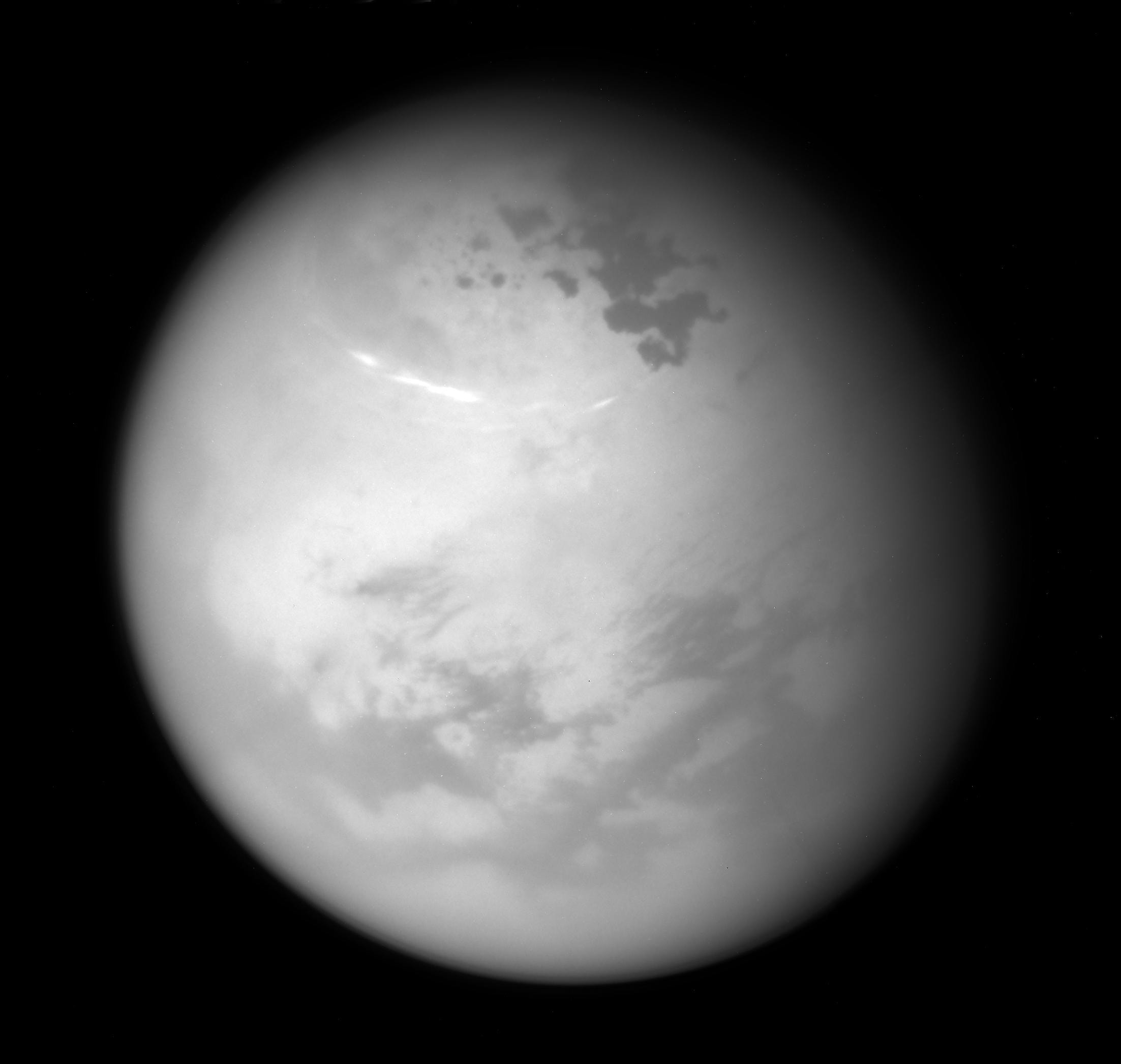 While yesterday's solstice brought summer to planet Earth's northern hemisphere, a northern summer solstice arrived for ringed planet Saturn nearly a month ago on May 24. Following the Saturnian seasons, its large moon Titan was captured in this Cassini spacecraft image from June 9. The near-infrared view finds bright methane clouds drifting through Titan's northern summer skies as seen from a distance of about 507,000 kilometers. Below Titan's clouds, dark hydrocarbon lakes sprawl near the large moon's now illuminated north pole.