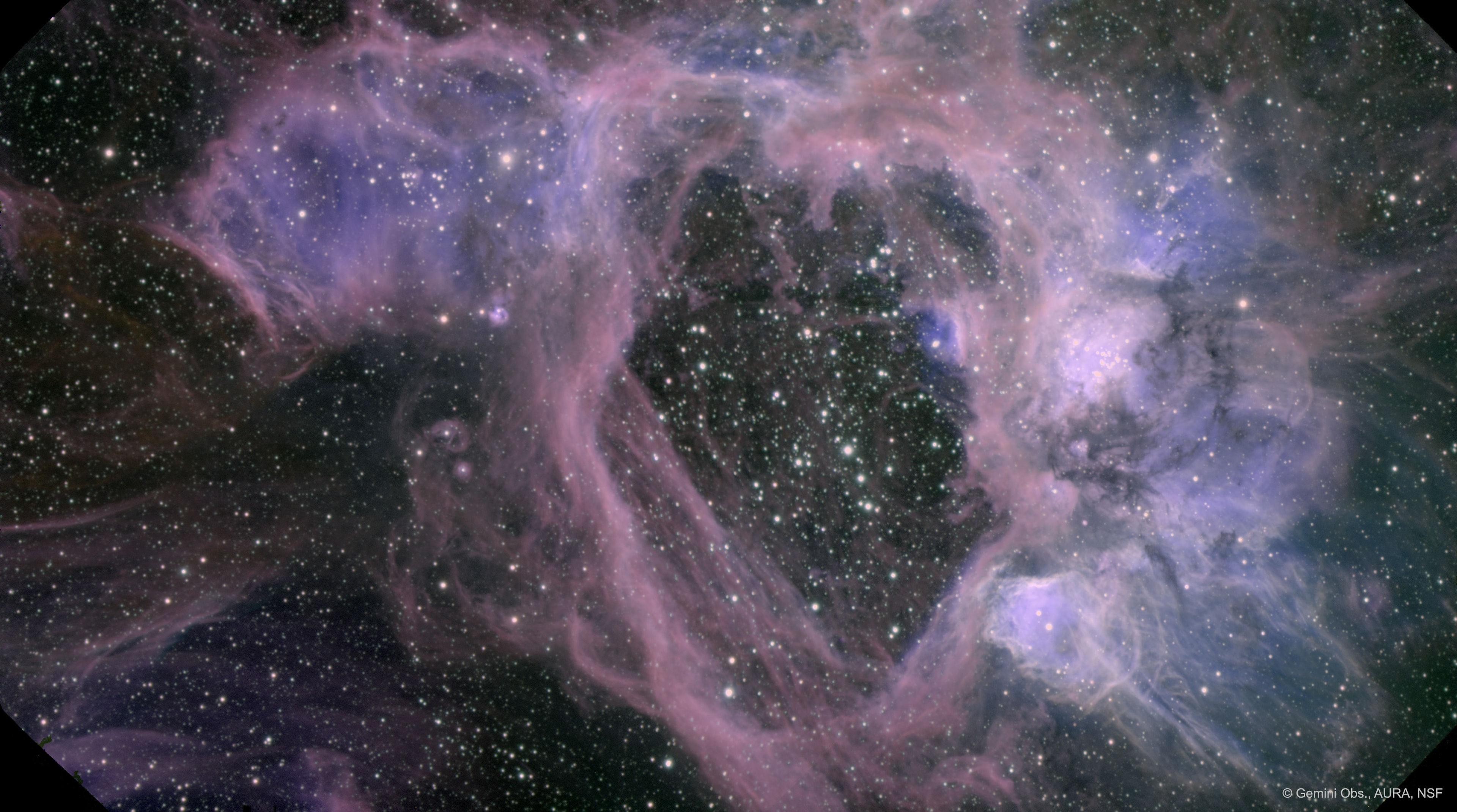 What created this gigantic hole? The vast emission nebula N44 in our neighboring galaxy the Large Magellanic Cloud has a large, 250 light-year hole and astronomers are trying to figure out why. One possibility is particle winds expelled by massive stars in the bubble's interior that are pushing out the glowing gas. This answer was found to be inconsistent with measured wind velocities, however. Another possibility is that the expanding shells of old supernovas have sculpted the unusual space cavern. An unexpected clue of hot X-ray emitting gas was recently been detected escaping the N44 superbubble. The featured image was taken in three very specific colors by the huge 8-meter Gemini South Telescope on Cerro Pachon in Chile. Follow APOD on: Facebook, Google Plus, Instagram, or Twitter
