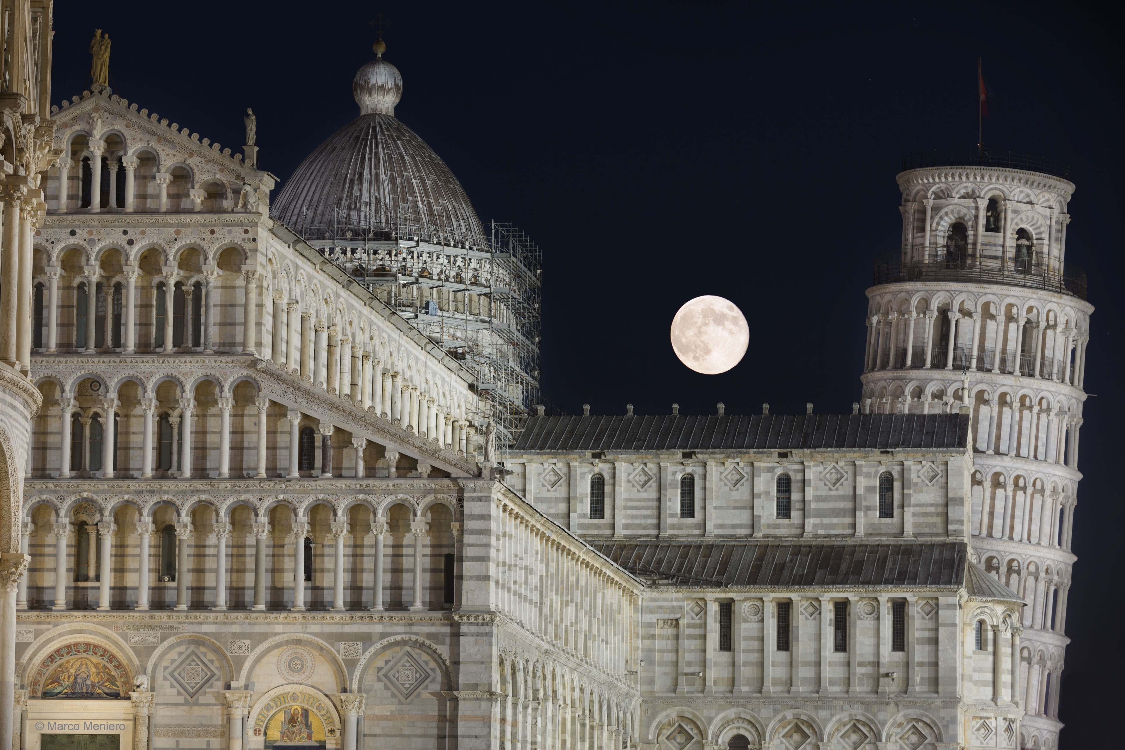 What's wrong with this picture? If you figure it out, you may then realize where the image was taken. The oddity lies actually in one of the buildings -- it leans. The Leaning Tower of Pisa has been an iconic legend since shortly after its construction began in the year 1173. Now part of a UNESCO World Heritage Site, folklore holds that Galileo used the leaning tower to dramatically demonstrate the gravitational principle that objects of different mass fall the same. Between the Leaning Tower of Pisa on the right and Pisa Cathedral and the Pisa Baptistery on the left, a full "Thunder" moon was visible last week when the image composite was taken. Using modern analyses, the tower has been successfully stabilized and, barring the unexpected, should hold its present tilt for the next 200 years. Indonesia: New APOD Mirror Site in Indonesian