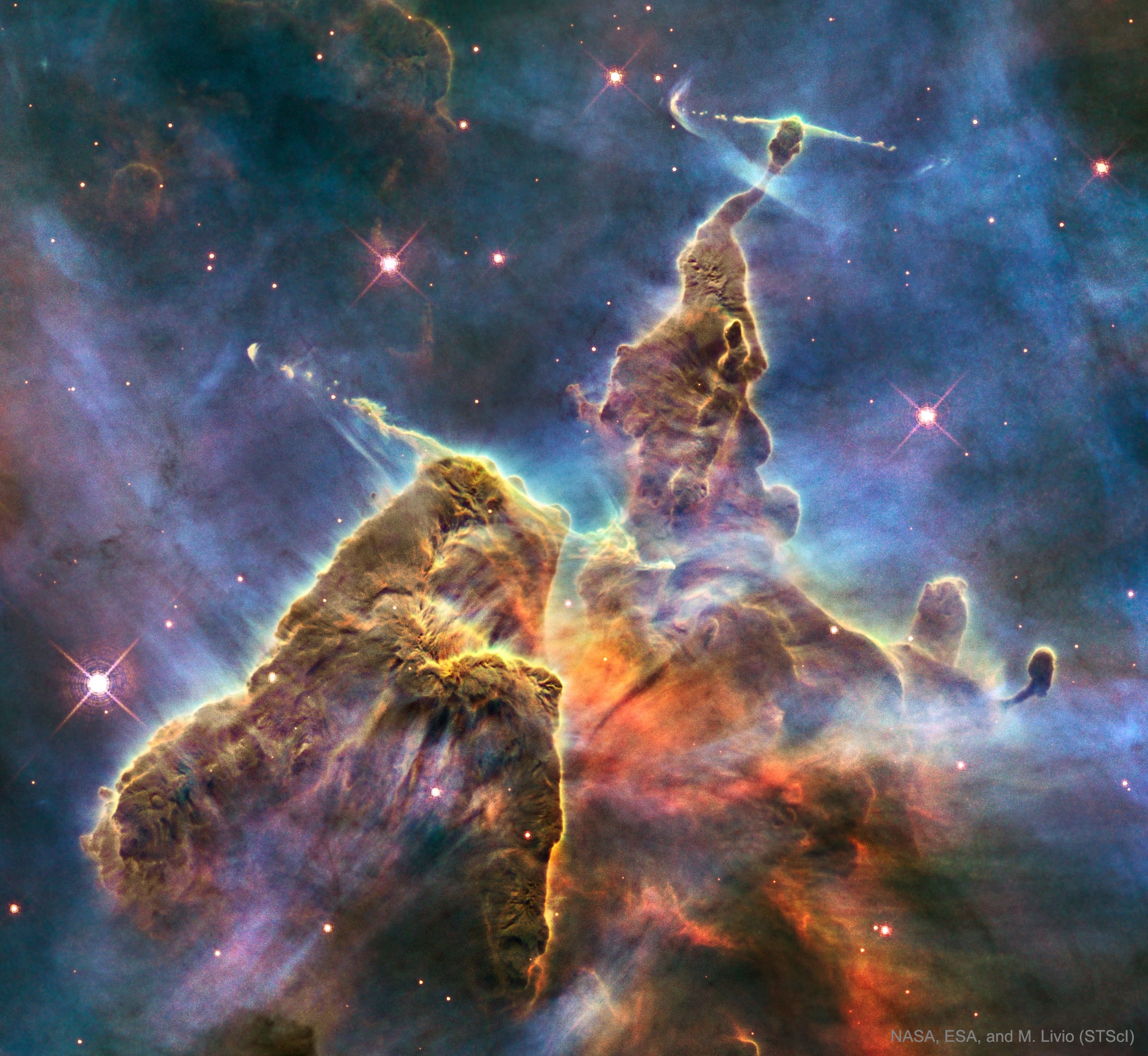 It's stars versus dust in the Carina Nebula and the stars are winning. More precisely, the energetic light and winds from massive newly formed stars are evaporating and dispersing the dusty stellar nurseries in which they formed. Located in the Carina Nebula and known informally as Mystic Mountain, these pillar's appearance is dominated by the dark dust even though it is composed mostly of clear hydrogen gas. Dust pillars such as these are actually much thinner than air and only appear as mountains due to relatively small amounts of opaque interstellar dust. About 7,500 light-years distant, the featured image was taken with the Hubble Space Telescope and highlights an interior region of Carina which spans about three light years. Within a few million years, the stars will likely win out completely and the entire dust mountain will evaporate.