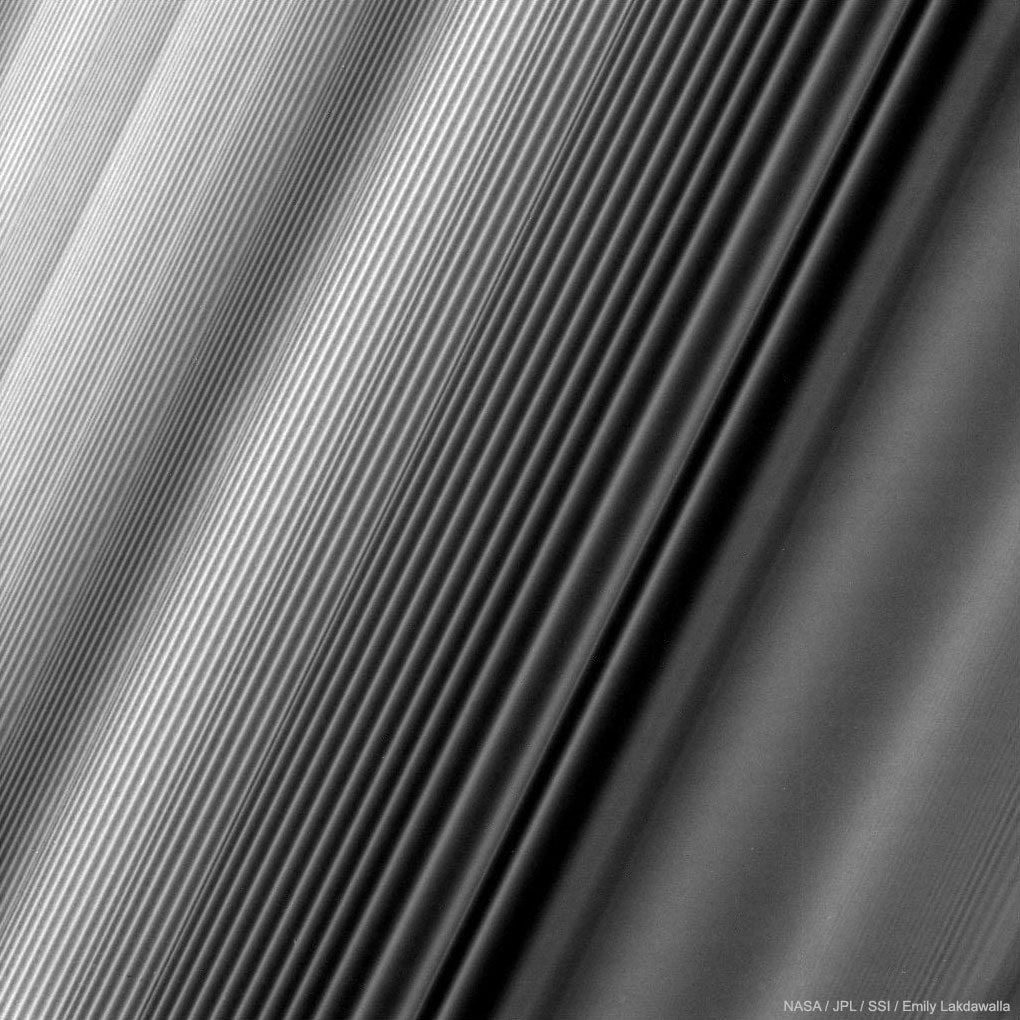 What causes the patterns in Saturn's rings? The Cassini spacecraft, soon ending its 13 years orbiting Saturn, has sent back another spectacular image of Saturn's immense ring system in unprecedented detail. The physical cause for some of Saturn's ring structures is not always understood. The cause for the beautifully geometric type of ring structure shown here in ring of Saturn, however, is surely a density wave. A small moon systematically perturbing the orbits of ring particles circling Saturn at slightly different distances causes such a density wave bunching. Also visible on the lower right of the image is a bending wave, a vertical wave in ring particles also caused by the gravity of a nearby moon. Cassini's final orbits are allowing a series of novel scientific measurements and images of the Solar System's most grand ring system. Open Science: Browse 1,500+ codes in the Astrophysics Source Code Library