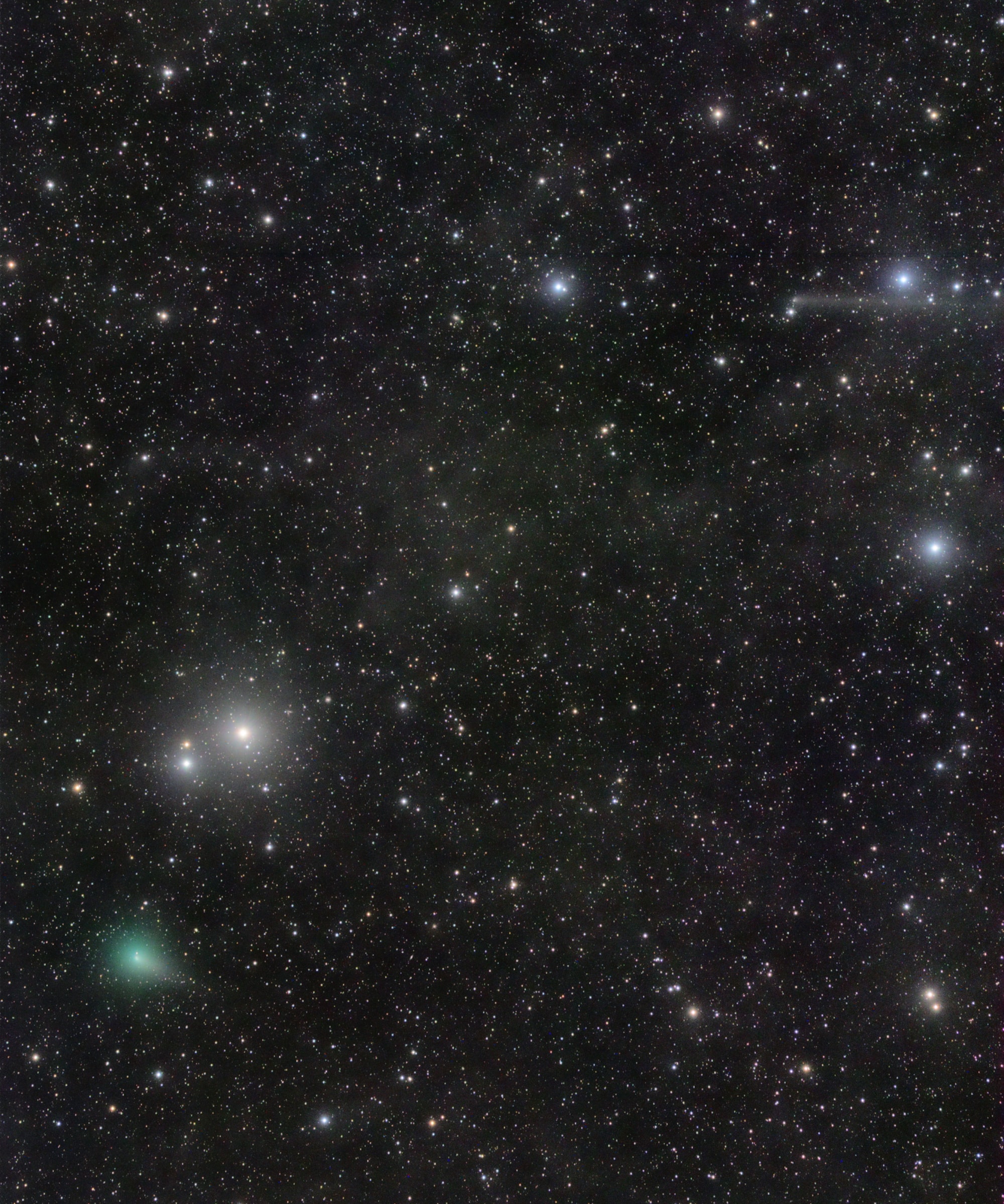 A conjunction of comets is captured in this pretty star field from the morning of September 17. Discovered in July by a robotic sky survey searching for supernovae, comet C/2017 O1 ASASSN is at the lower left. The visible greenish glow of its coma is produced by the fluorescence of diatomic carbon molecules in sunlight. Nearing its closest approach to the Sun, the binocular comet was only about 7.2 light-minutes from Earth. In the same telescopic field of view is the long-tailed, outbound comet C/2015 ER61 PanSTARRS at the upper right, almost 14 light-minutes away. Many light-years distant, the starry background includes faint, dusty nebulae of the Milky Way. The well-known Pleiades star cluster lies just off the top right of the frame.