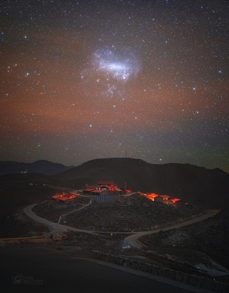 The Large Magellanic Cloud, a satellite galaxy of the Milky Way, stands above the southern horizon in this telephoto view from Las Campanas Observatory, planet Earth. In the dark September skies of the Chilean Atacama desert, the small galaxy has an impressive span of about 10 degrees or 20 Full Moons. The sensitive digital camera's panorama has also recorded a faint, pervasive airglow, otherwise invisible to the eye. Apparently bright terrestrial lights in the foreground are actually very dim illumination from the cluster of housing for the observatory astronomers and engineers. But the flattened mountain top along the horizon just under the galaxy is Las Campanas peak, home to the future Giant Magellan Telescope.