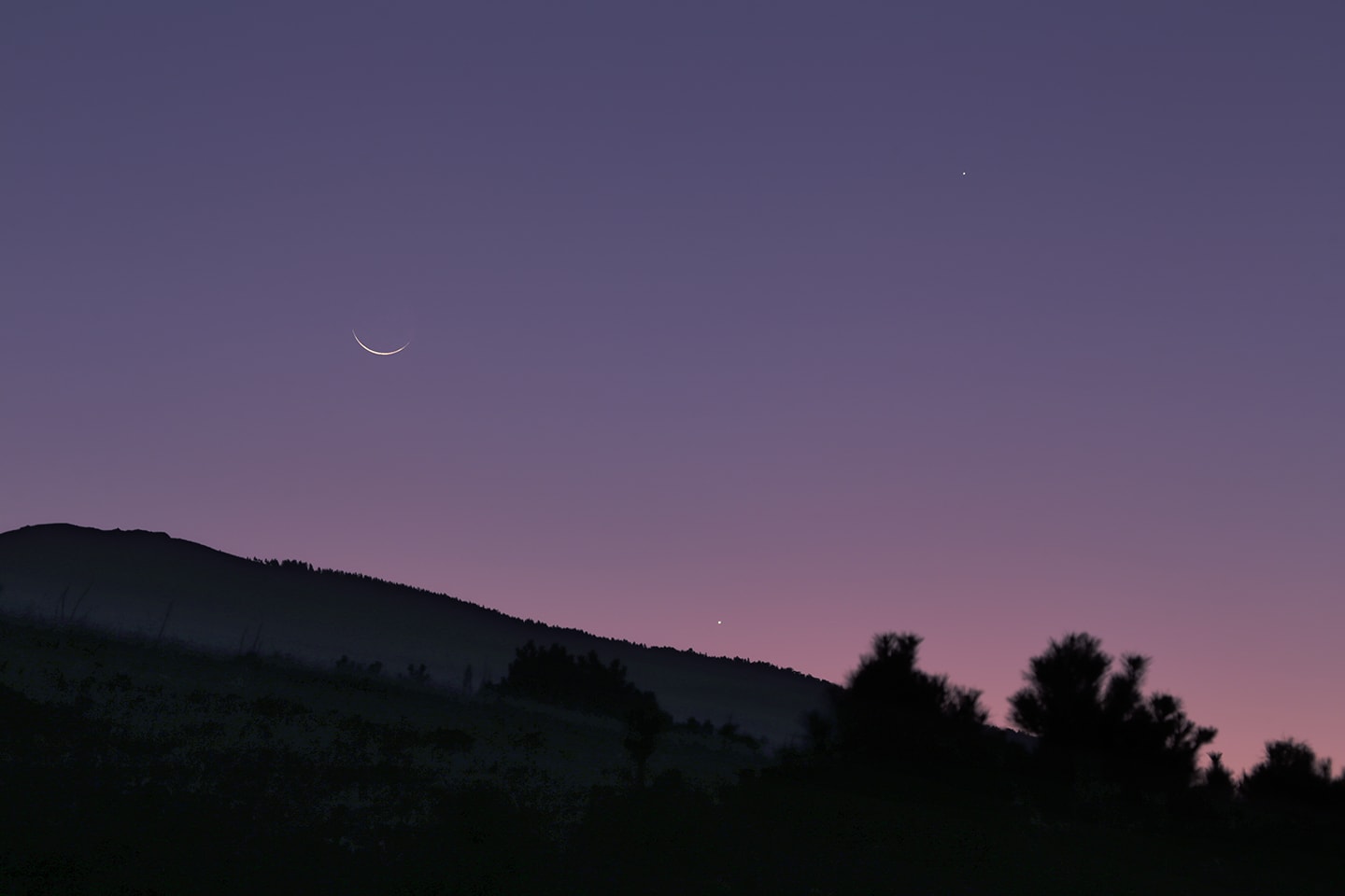 Friday, an old Moon smiled for early morning risers. Its waning sunlit crescent is captured in this atmospheric scene from clear skies near Bursa, Turkey, planet Earth. In the subtle twilight hues nearby celestial lights are Jupiter (top) and Venus shining close to the eastern horizon. But today, Saturday, the Moon will be new and early next week its waxing crescent will follow the setting Sun as it sinks in the west. Then, a young Moon's smile will join Saturn and Mercury in early evening skies. Watch: Leonid Meteor Shower