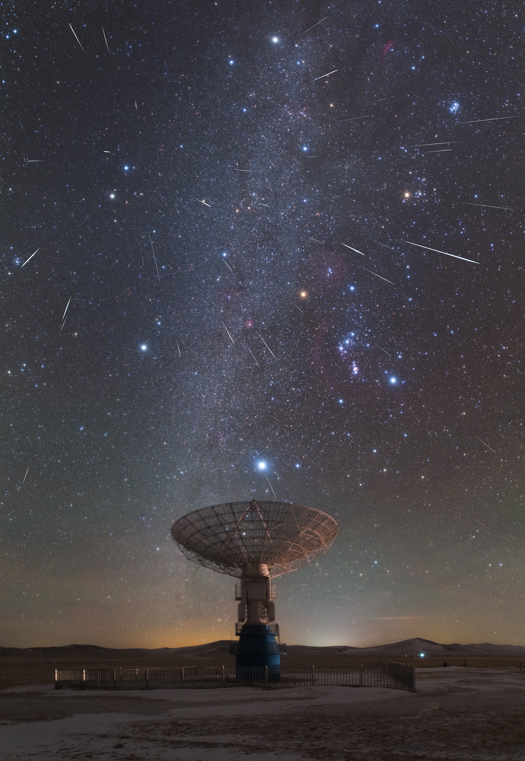 rth's annual Geminid meteor shower did not disappoint as our fair planet plowed through dust from active asteroid 3200 Phaethon. Captured in this northern hemisphere nightscape, the meteors stream away from the shower's radiant in Gemini. To create the image, 37 individual frames recording meteor streaks were taken over period of 8.5 hours during the night of December 12/13. In the final composite they were selected and registered against the starry sky above a radio telescope dish of MUSER, a solar-dedicated radio telescope array at astronomically-named Mingantu Station in Inner Mongolia, China, about 400 kilometers from Beijing. Sirius, alpha star of Canis Major, shines brightly just above the radio dish and the Milky Way stretches toward the zenith. Yellowish Betelgeuse is a standout in Orion to the right of the northern Milky Way. The shower's radiant is at top left, high above the horizon near Castor and Pollux the twin stars of Gemini. The radiant effect is due to perspective as the parallel meteor tracks appear to converge in the distance. Gemini's meteors enter Earth's atmosphere traveling at about 22 kilometers per second. Submitted to APOD: Best images (so far) of the Geminid Meteor Shower 2017.