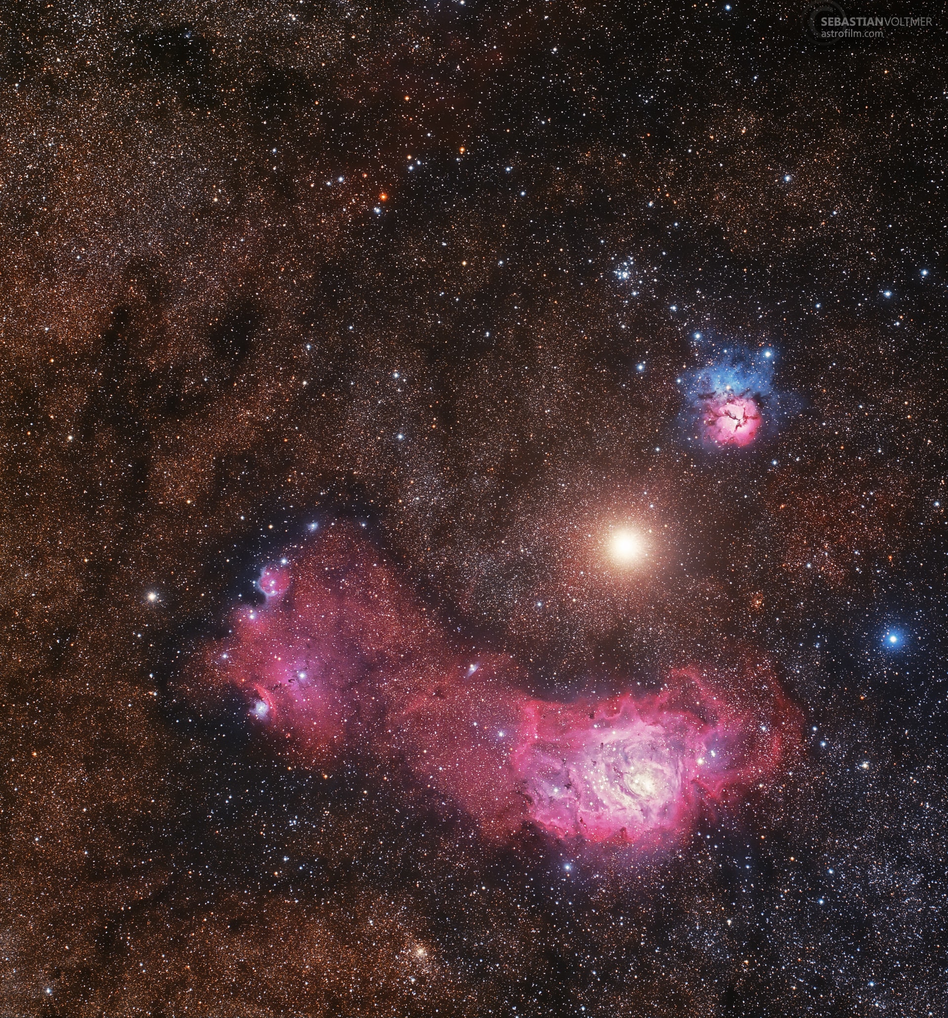 What's that bright red spot between the Lagoon and Trifid Nebulas? Mars. This gorgeous color deep-sky photograph captured the red planet passing between the two notable nebulas -- cataloged by the 18th century cosmic registrar Charles Messier as M8 and M20. M20 (upper right of center), the Trifid Nebula, presents a striking contrast in red/blue colors and dark dust lanes. Across the bottom right is the expansive, alluring red glow of M8, the Lagoon Nebula. Both nebulae are a few thousand light-years distant. By comparison, temporarily situated between them both, is the dominant "local" celestial beacon Mars. Taken last week, the red planet was only about 10 light-minutes away. Gallery: Mars in Sagittarius