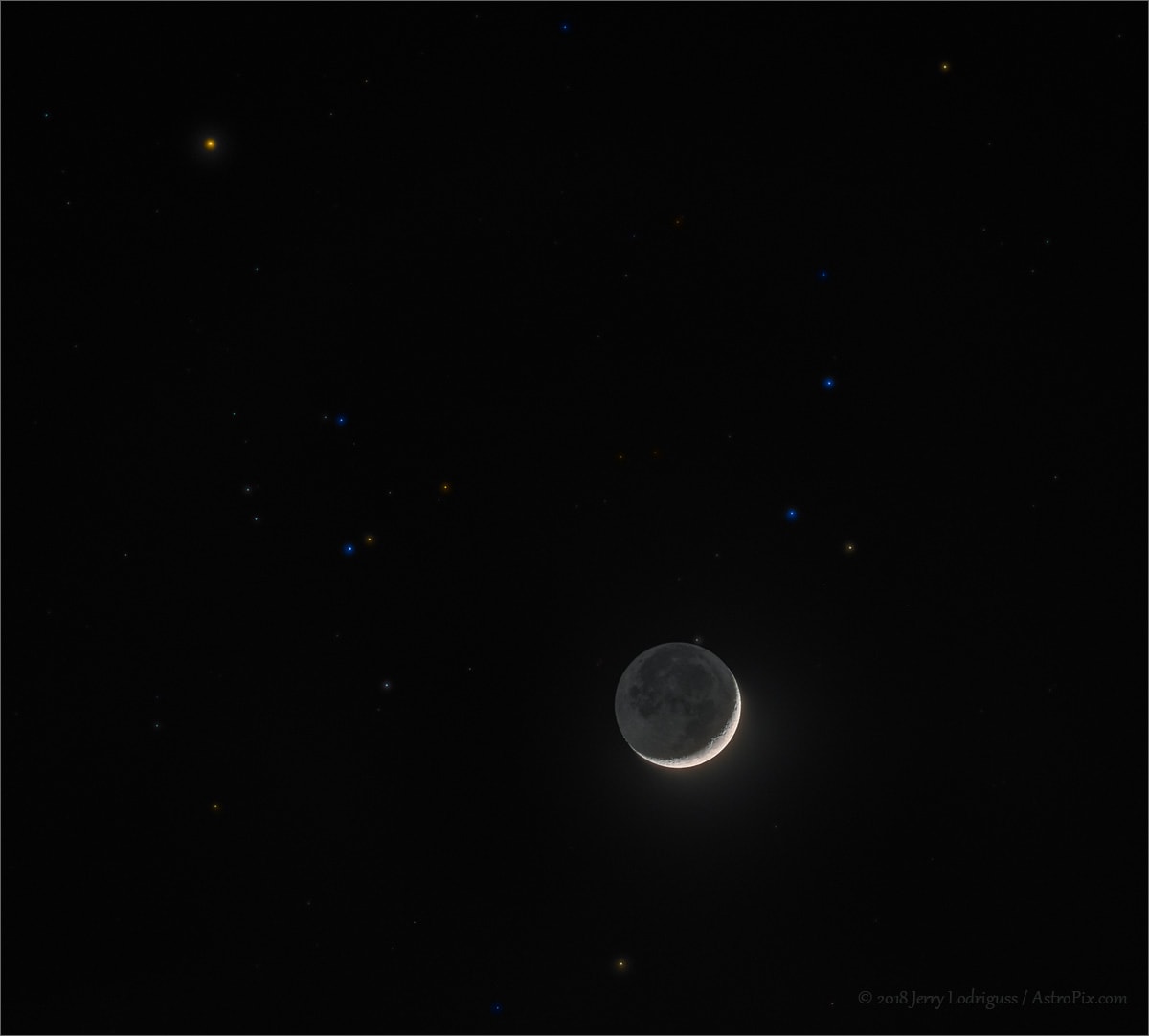 Have you seen the Moon lately? On April 18, its waxing sunlit crescent moved through planet Earth's night across a background of stars in the Hyades. Anchored by bright star Aldebaran, the nearby, V-shaped star cluster and complete lunar orb appear in this telephoto image. The engaging skyview is actually digitally composed from a series of varying exposures. Recorded in 1/60th of a second, the shortest in the series captures the Moon's bright crescent in sharp detail. Longer exposures, ranging up to 15 seconds, capture fainter background stars as well as earthshine, visible to the eye as the earthlit lunar night side.