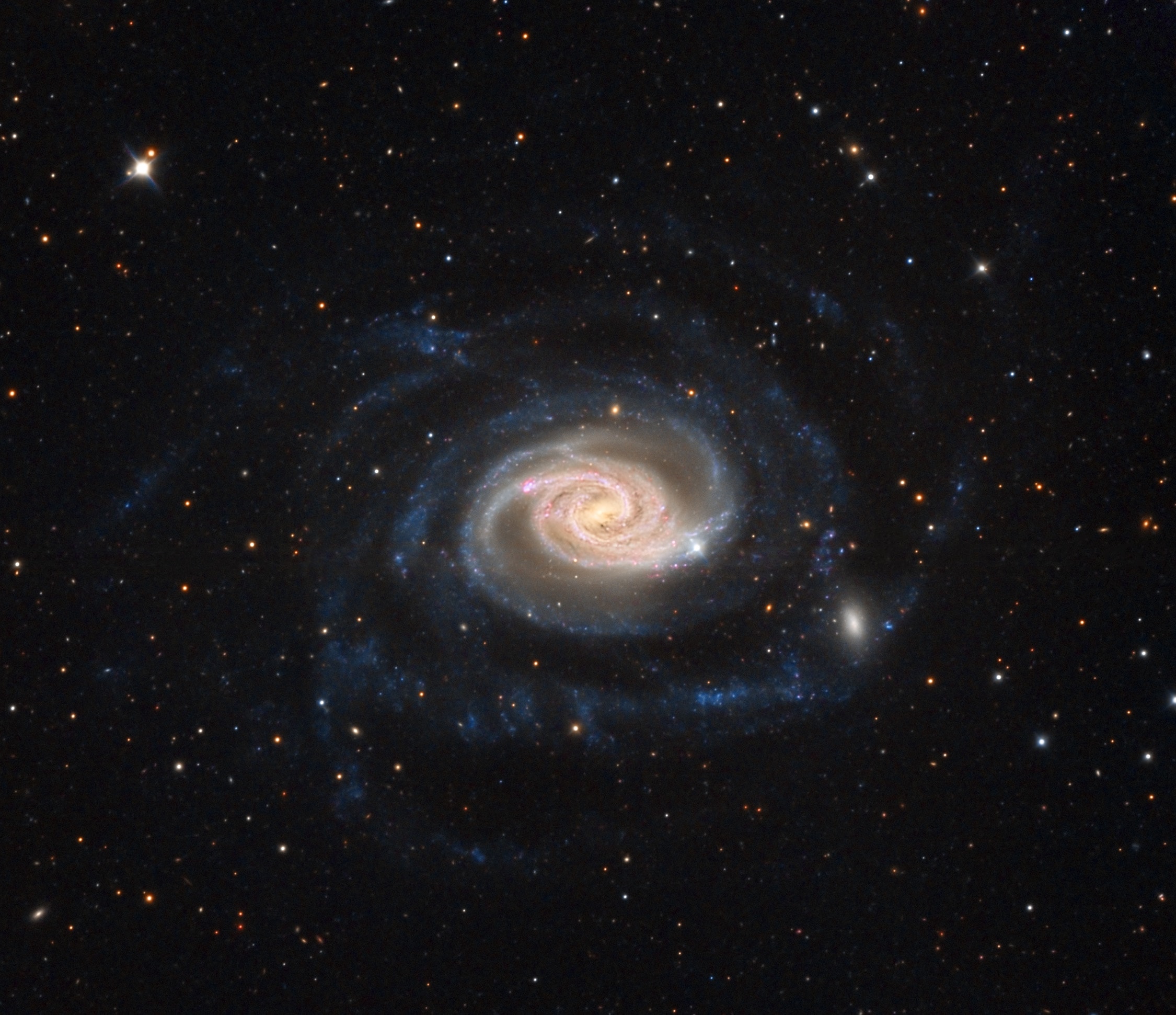 About 70 million light-years distant, gorgeous spiral galaxy NGC 289 is larger than our own Milky Way. Seen nearly face-on, its bright core and colorful central disk give way to remarkably faint, bluish spiral arms. The extensive arms sweep well over 100 thousand light-years from the galaxy's center. At the lower right in this sharp, telescopic galaxy portrait the main spiral arm seems to encounter a small, fuzzy elliptical companion galaxy interacting with enormous NGC 289. Of course the spiky stars are in the foreground of the scene. They lie within the Milky Way toward the southern constellation Sculptor.