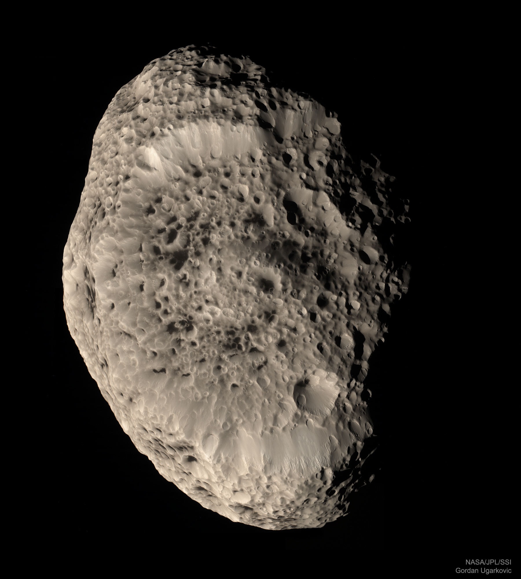 What lies at the bottom of Hyperion's strange craters? To help find out, the robot Cassini spacecraft that once orbited Saturn swooped past the sponge-textured moon in 2005 and 2010 and took images of unprecedented detail. A six-image mosaic from the 2005 pass, featured here in natural color, shows a remarkable world strewn with strange craters and an odd sponge-like surface. At the bottom of most craters lies some type of unknown dark reddish material. This material appears similar to that covering part of another of Saturn's moons, Iapetus, and might sink into the ice moon as it better absorbs warming sunlight. Hyperion is about 250 kilometers across, rotates chaotically, and has a density so low that it likely houses a vast system of caverns inside.
