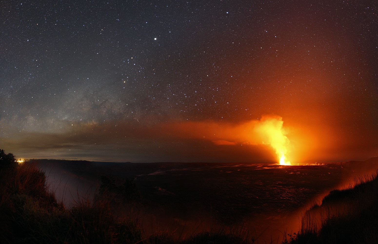 Volcanic activity on the Big Island of Hawaii has increased since this Hawaiian night skyscape was recorded earlier this year. Recent vents and lava flows are about 30 kilometers to the east, the direction of the blowing smoke and steam in the panoramic view of the Kilauea caldera with Halemaumau crater taken from Volcanoes National Park. Still, this year Jupiter is bright in late spring to early summer skies. High in the south it is easily the brightest celestial beacon in the scene where the central bulge of the Milky Way seems to rise above vapors and clouds. Yellowish Antares is the bright star near the end of the dark rivers of dust seen toward the center of our galaxy. Near the horizon, stars Alpha and Beta Centauri and the compact Southern Cross shine through the almost too bright volcanic smoke.
