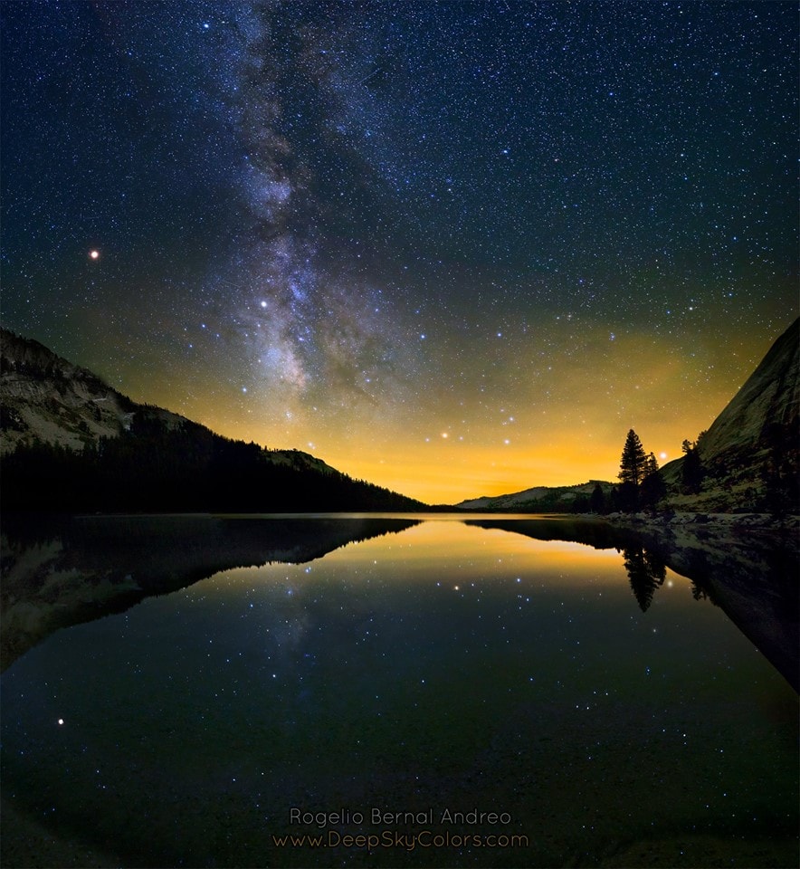 The five naked-eye planets, Mercury, Venus, Mars, Jupiter and Saturn, have been seen since ancient times to wander the night skies of planet Earth. So it could be remarkable that on this night, standing at the side of a clear, calm lake, six planets can be seen with the unaided eye. Have a look. Very bright and easy to spot for skygazers, yellowish Mars is left of a pale Milky Way. Saturn is immersed in the glow of the Milky Way's diffuse starlight. Jupiter is very near the horizon on the right, shining beyond the trees against the glow of distant city lights. Last weekend, while admiring this night time view across beautiful, high-altitude Lake Tenaya in Yosemite National Park, a thoughtful and reflective observer could probably see three planets more.