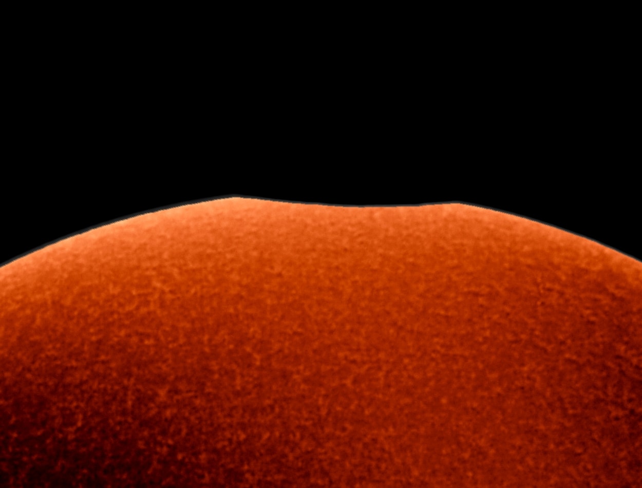 The smallest of the three partial solar eclipses during 2018 was just yesterday, Friday, July 13. It was mostly visible over the open ocean between Australia and Antarctica. Still, this video frame of a tiny nibble on the Sun was captured through a hydrogen-alpha filter from Port Elliott, South Australia, during the maximum eclipse visible from that location. There, the New Moon covered about 0.16 percent of the solar disk. The greatest eclipse, about one-third of the Sun's diameter blocked by the New Moon, could be seen from East Antarctica near Peterson Bank, where the local emperor penguin colony likely had the best view. During this prolific eclipse season, the coming Full Moon will bring a total lunar eclipse on July 27, followed by yet another partial solar eclipse at the next New Moon on August 11.
