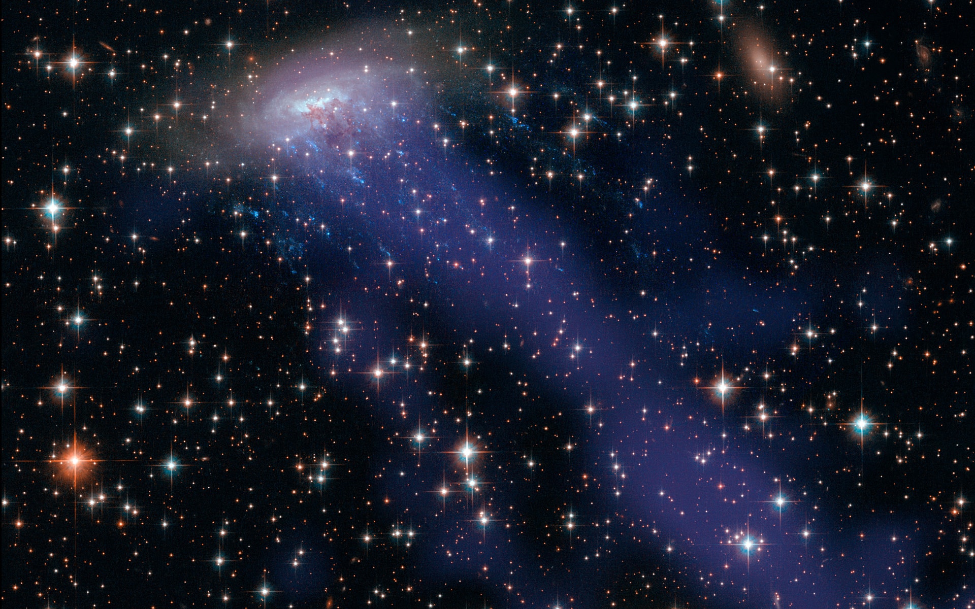 Spiral galaxy ESO 137-001 hurtles through massive galaxy cluster Abell 3627 some 220 million light years away. The distant galaxy is seen in this colorful Hubble/Chandra composite image through a foreground of the Milky Way's stars toward the southern constellation Triangulum Australe. As the spiral speeds along at nearly 7 million kilometers per hour, its gas and dust are stripped away when ram pressure with the cluster's own hot, tenuous intracluster medium overcomes the galaxy's gravity. Evident in Hubble's near visible light data, bright star clusters have formed in the stripped material along the short, trailing blue streaks. Chandra's X-ray data shows off the enormous extent of the heated, stripped gas as diffuse, darker blue trails stretching over 400,000 light-years toward the bottom right. The significant loss of dust and gas will make new star formation difficult for this galaxy. A yellowish elliptical galaxy, lacking in star forming dust and gas, is just to the right of ESO 137-001 in the frame.
