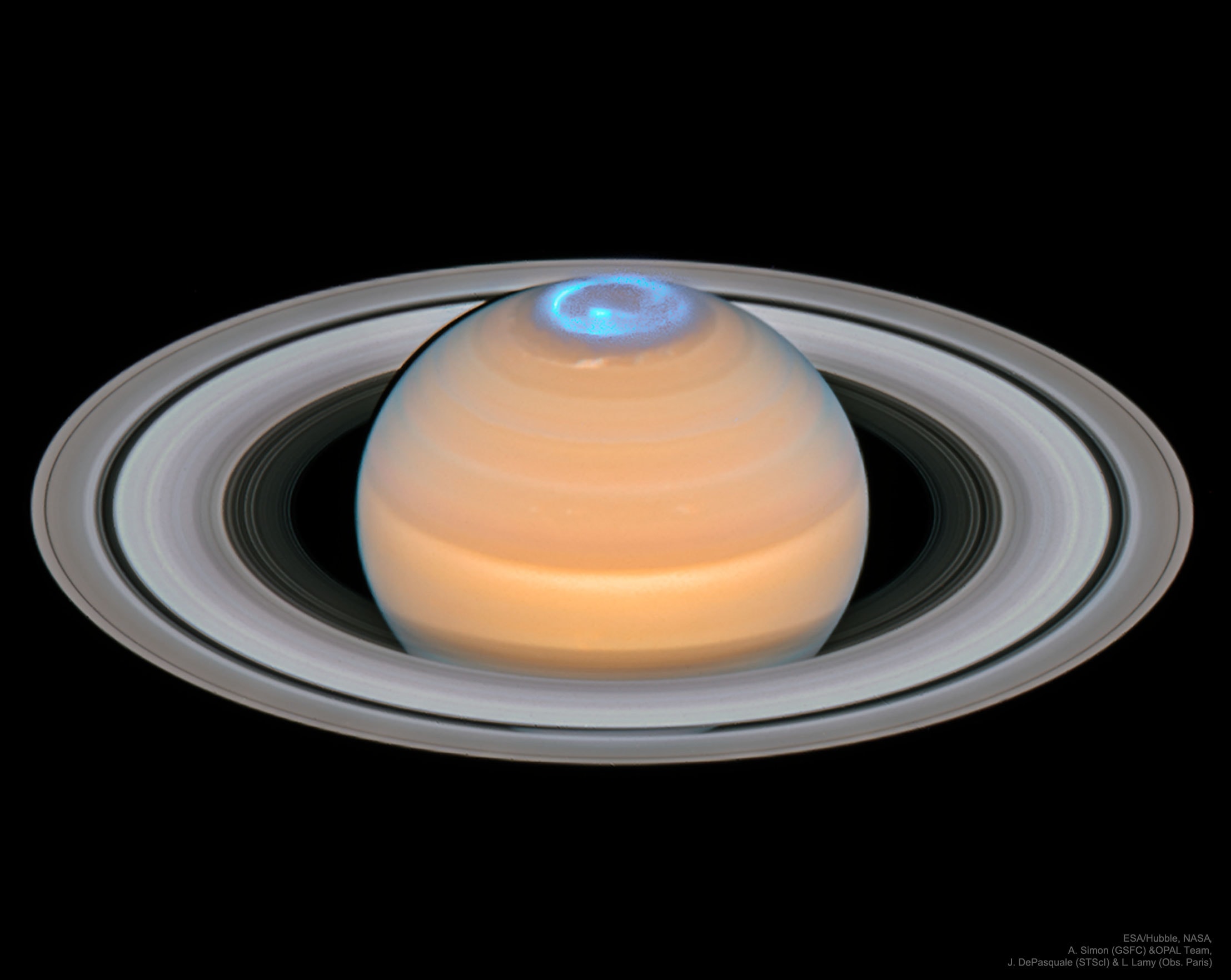 Are Saturn's auroras like Earth's? To help answer this question, the Hubble Space Telescope and the Cassini spacecraft monitored Saturn's North Pole simultaneously during Cassini's final orbits around the gas giant in September 2017. During this time, Saturn's tilt caused its North Pole to be clearly visible from Earth. The featured image is a composite of ultraviolet images of aurora and optical images of Saturn's clouds and rings, all taken recently by Hubble. Like on Earth, Saturn's northern auroras can make total or partial rings around the pole. Unlike on Earth, however, Saturn's auroras are frequently spirals -- and more likely to peak in brightness just before midnight and dawn. In contrast to Jupiter's auroras, Saturn's auroras appear better related to connecting Saturn's internal magnetic field to the nearby, variable, solar wind. Saturn's southern auroras were similarly imaged back in 2004 when the planet's South Pole was clearly visible to Earth. Teachers: APOD in the Classroom