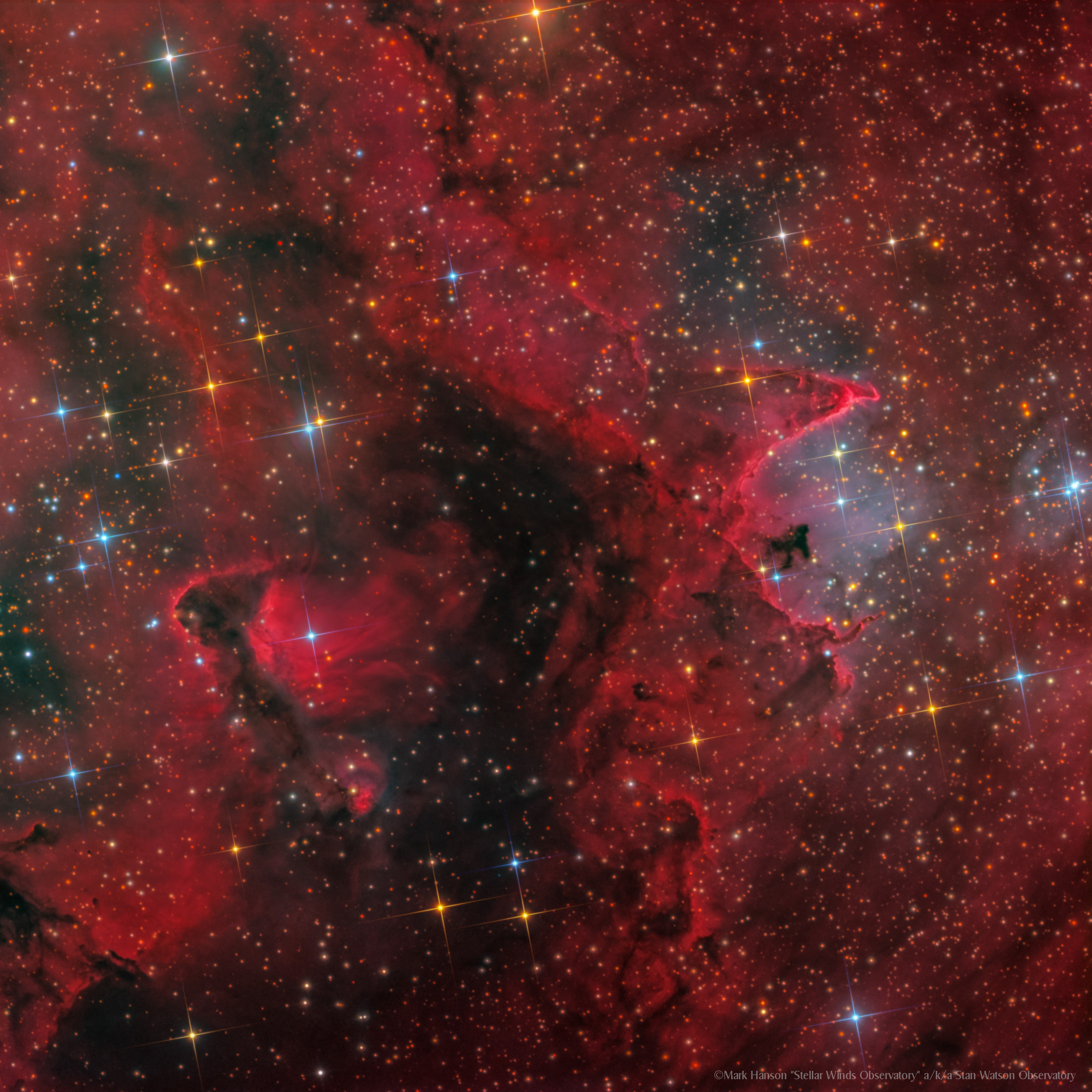 This cosmic close-up looks deep inside the Soul Nebula. The dark and brooding dust clouds on the left, outlined by bright ridges of glowing gas, are cataloged as IC 1871. About 25 light-years across, the telescopic field of view spans only a small part of the much larger Heart and Soul nebulae. At an estimated distance of 6,500 light-years the star-forming complex lies within the Perseus spiral arm of our Milky Way Galaxy, seen in planet Earth's skies toward the constellation Cassiopeia. An example of triggered star formation, the dense star-forming clouds of IC 1871 are themselves sculpted by the intense winds and radiation of the region's massive young stars. The featured image appears mostly red due to the emission of a specific color of light emitted by excited hydrogen gas.