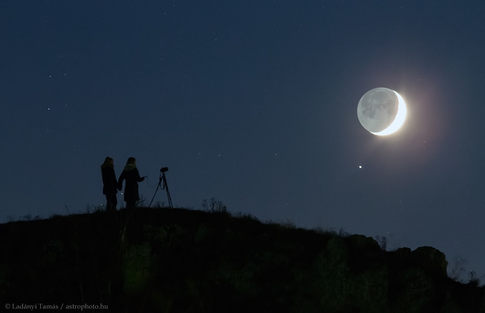 Last Sunday when the Moon was young its sunlit crescent hung low near the western horizon at sunset. With strong earthshine it was joined by Saturn shining in the early evening sky for a beautiful conjunction visible to skygazers around our fair planet. On that clear evening on a hill near Veszprem, Hungary mother, daughter, bright planet, and young Moon are framed in this quiet night skyscape taken with a telephoto lens. Of course the Moon ages too quickly for some, and by tonight the sunlit part has reached its first quarter phase. This weekend skygazers spending quality time under Moon and stars might expect to see the annual rain of comet dust otherwise known as the Leonid meteor shower. How to: Photograph the Leonid Meteor Shower