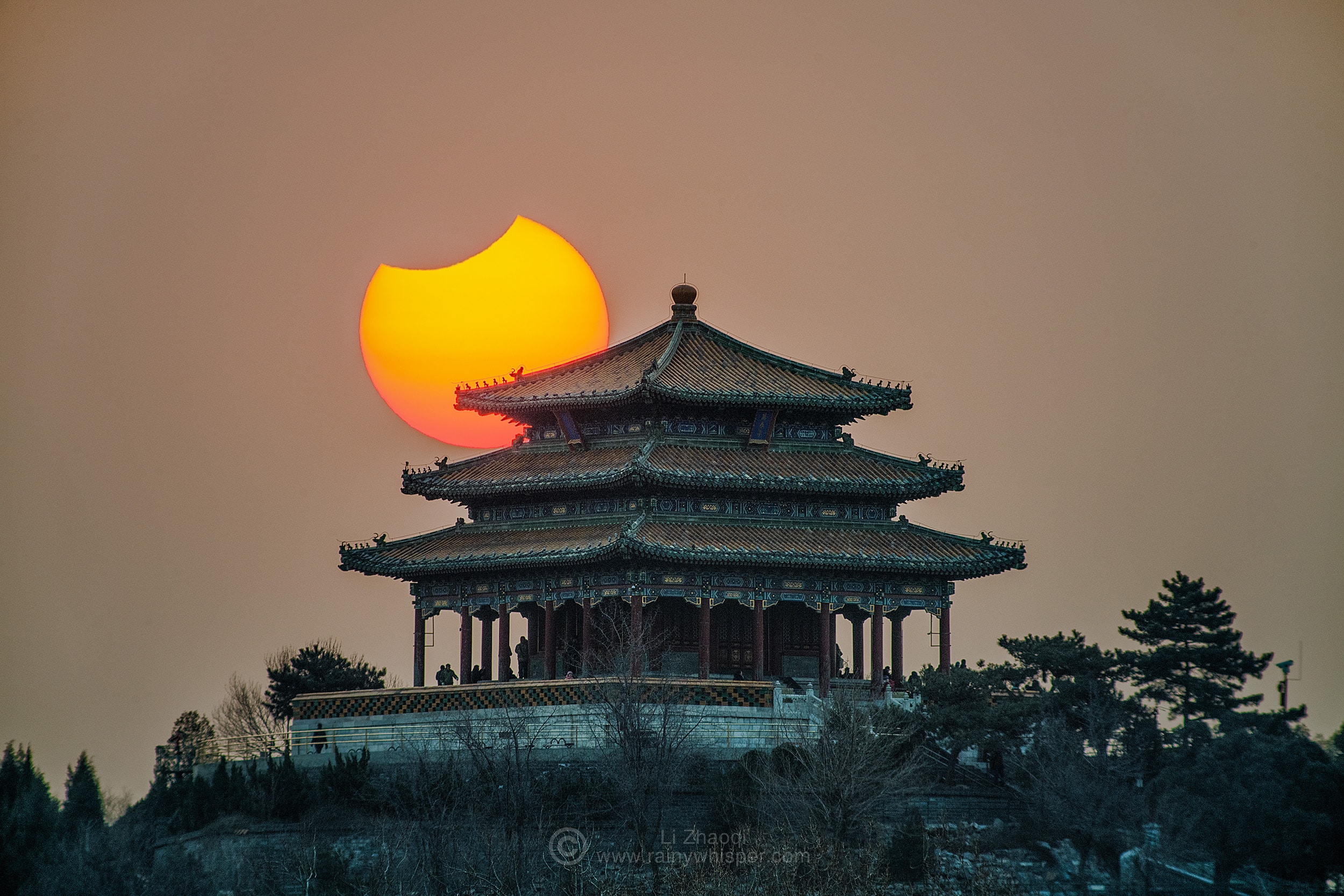 On January 6 the New Moon rose in silhouette with the Sun seen from northeastern Asia. Near maximum, the dramatic partial solar eclipse is captured in this telephoto view through hazy skies. In the foreground, the hill top Wanchun pavilion overlooking central Beijing's popular Forbidden City hosts eclipse-watching early morning risers. This was the first of five, three solar and two lunar, eclipses for 2019. Next up is a total lunar eclipse during this month's Full Perigee Moon. At night on January 21, that celestial shadow play will be visible from the hemisphere of planet Earth that includes the Americas, Europe, and western Africa.