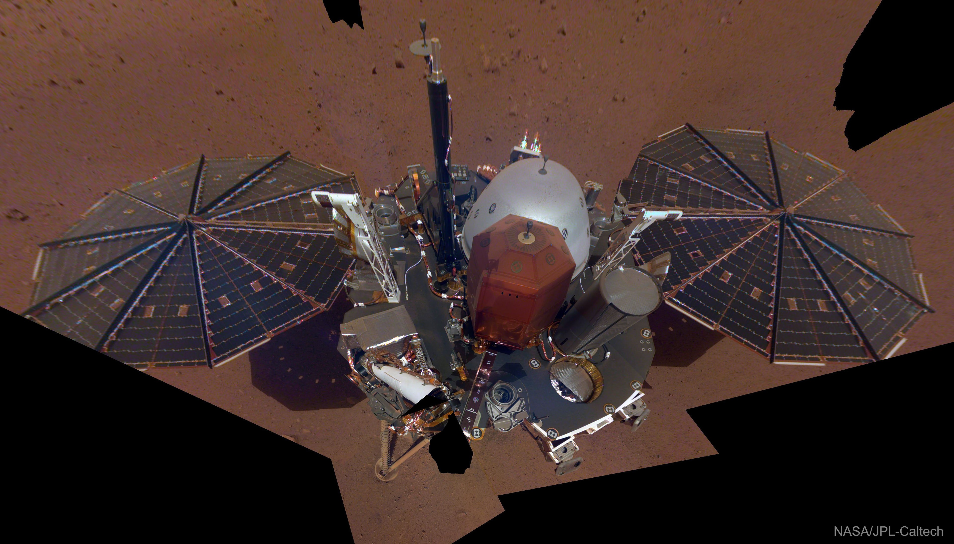 This is what NASA's Insight lander looks like on Mars. With its solar panels, InSight is about the size of a small bus. Insight successfully landed on Mars in November with a main objective to detect seismic activity. The featured selfie is a compilation of several images taken of different parts of the InSight lander, by the lander's arm, at different times. SEIS, the orange-domed seismometer seen near the image center last month, has now been placed on the Martian surface. With this selfie, Mars InSight continues a long tradition of robotic spacecraft on Mars taking and returning images of themselves, including Viking, Sojourner, Pathfinder, Spirit, Opportunity, Phoenix, and Curiosity. Data taken by Mars Insight is expected to give humanity unprecedented data involving the interior of Mars, a region thought to harbor formation clues not only about Mars, but Earth. Growing Gallery: Last Night's Total Lunar Eclipse