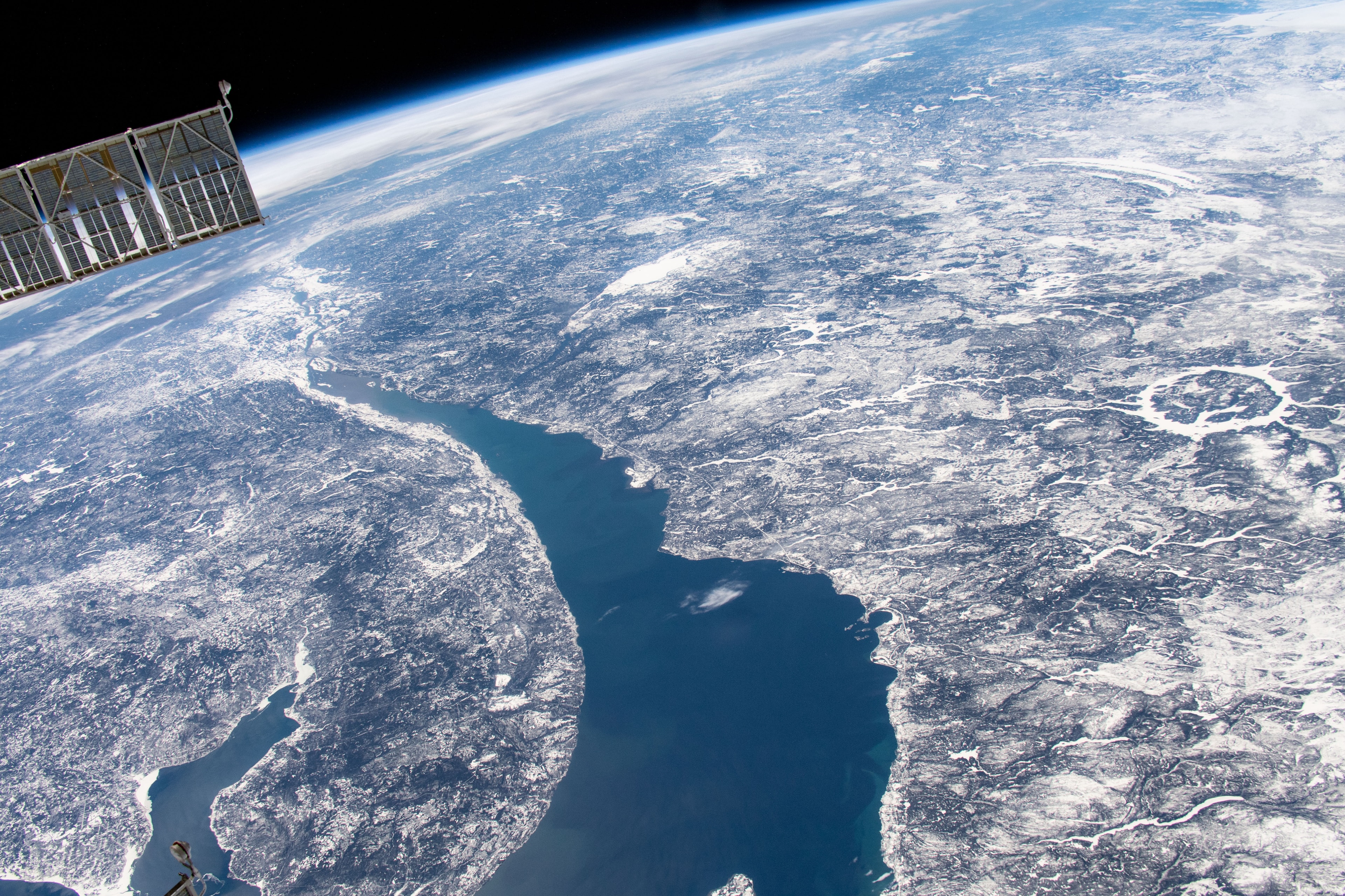 Orbiting 400 kilometers above Quebec, Canada, planet Earth, the International Space Station Expedition 59 crew captured this snapshot of the broad St. Lawrence River and curiously circular Lake Manicouagan on April 11. Right of center, the ring-shaped lake is a modern reservoir within the eroded remnant of an ancient 100 kilometer diameter impact crater. The ancient crater is very conspicuous from orbit, a visible reminder that Earth is vulnerable to rocks from space. Over 200 million years old, the Manicouagan crater was likely caused by the impact of a rocky body about 5 kilometers in diameter. Currently, there is no known asteroid with a significant probability of impacting Earth in the next century. But a fictional scenario to help practice for an asteroid impact is on going at the 2019 IAA Planetary Defense Conference.