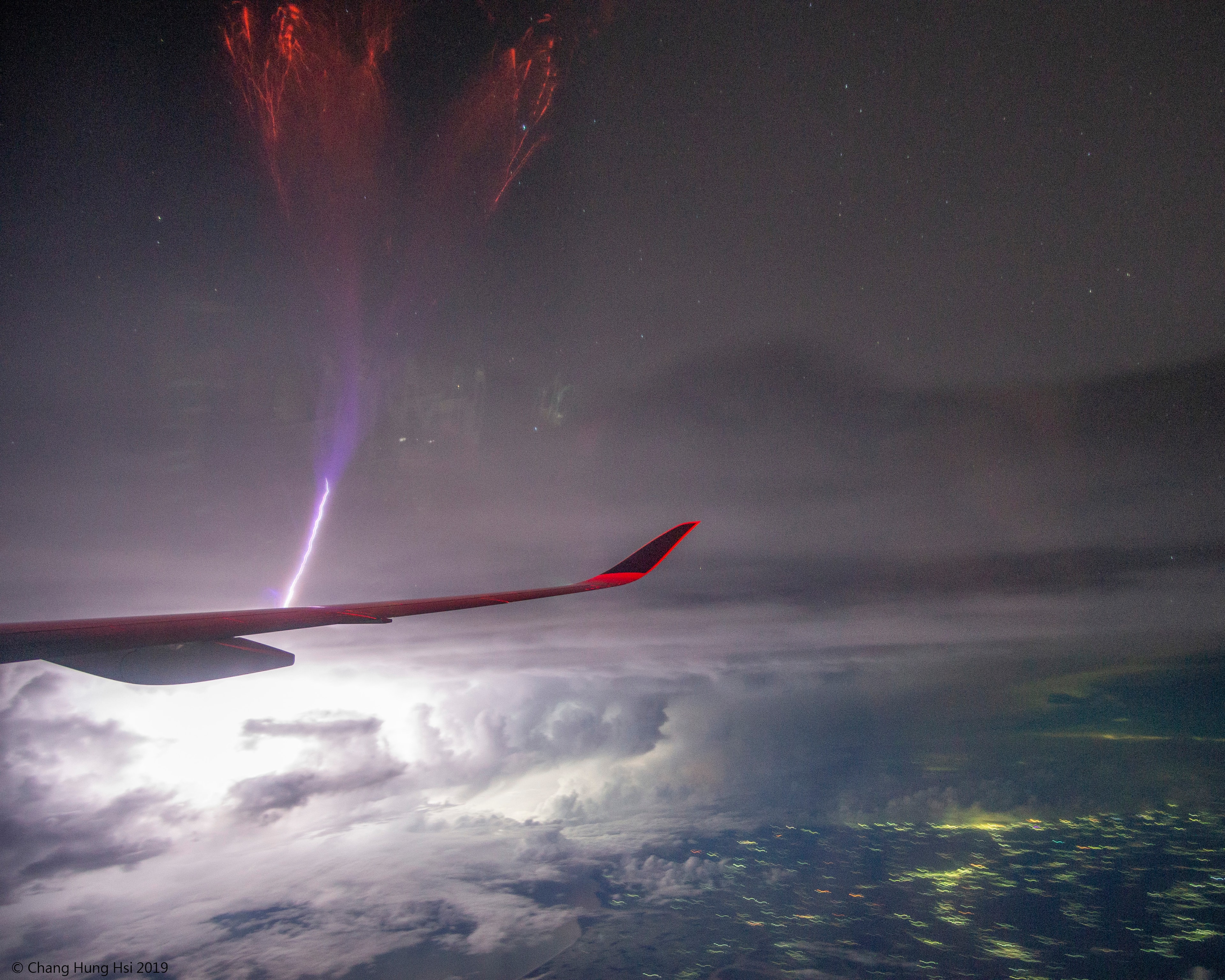 Yes, but can your lightning bolt do this? While flying from Munich to Singapore earlier this month, an industrious passenger took images of a passing lightning storm and caught something unexpected: gigantic jet lightning. The jet was captured on a single 3.2-second exposure above Bhadrak, India. Although the gigantic jet appears connected to the airplane's wing, it likely started in a more distant thundercloud, and can be seen extending upwards towards Earth's ionosphere. The nature of gigantic jets and their possible association with other types of Transient Luminous Events (TLEs) such as blue jets and red sprites remains an active topic of research.