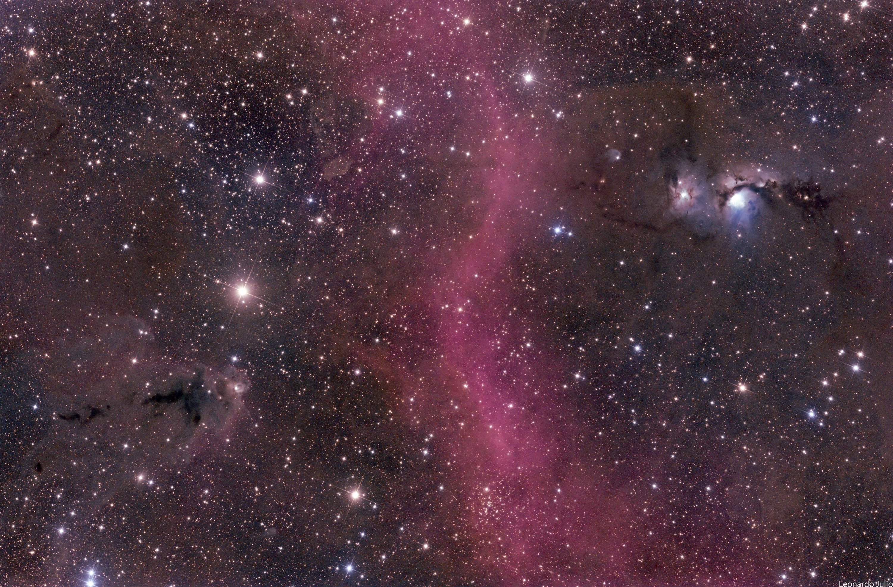 Bright stars, clouds of dust and glowing nebulae decorate this cosmic scene, a skyscape just north of Orion's belt. Close to the plane of our Milky Way galaxy, the wide field view spans about 5.5 degrees. Striking bluish M78, a reflection nebula, is on the right. M78's tint is due to dust preferentially reflecting the blue light of hot, young stars. In colorful contrast, the red sash of glowing hydrogen gas sweeping through the center is part of the region's faint but extensive emission nebula known as Barnard's Loop. At lower left, a dark dust cloud forms a prominent silhouette cataloged as LDN 1622. While M78 and the complex Barnard's Loop are some 1,500 light-years away, LDN 1622 is likely to be much closer, only about 500 light-years distant from our fair planet Earth.