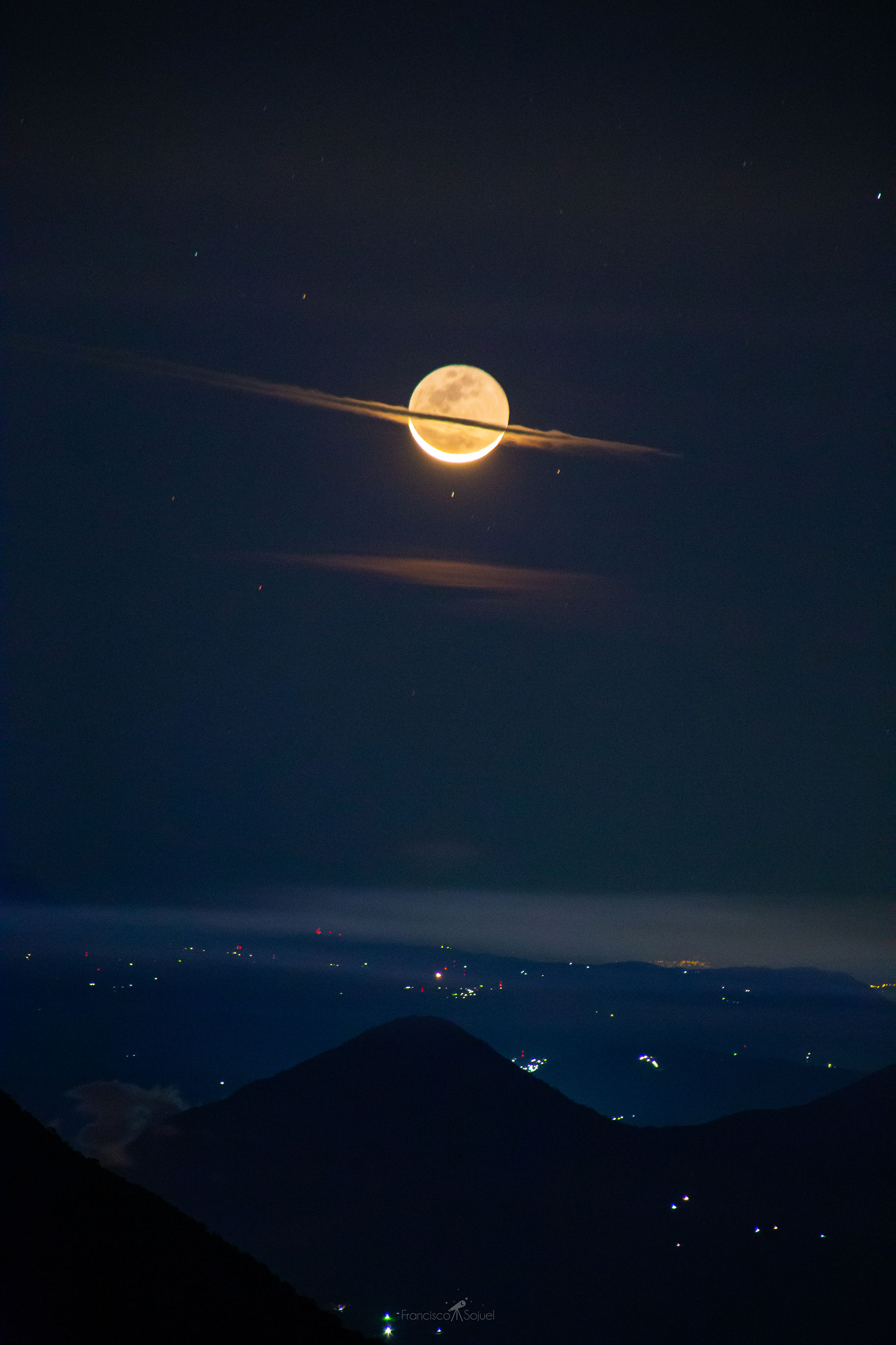 Why does Saturn appear so big? It doesn't -- what is pictured are foreground clouds on Earth crossing in front of the Moon. The Moon shows a slight crescent phase with most of its surface visible by reflected Earthlight known as ashen glow. The Sun directly illuminates the brightly lit lunar crescent from the bottom, which means that the Sun must be below the horizon and so the image was taken before sunrise. This double take-inducing picture was captured on 2019 December 24, two days before the Moon slid in front of the Sun to create a solar eclipse. In the foreground, lights from small Guatemalan towns are visible behind the huge volcano Pacaya. Follow APOD in English on: Instagram, Facebook, Reddit, or Twitter
