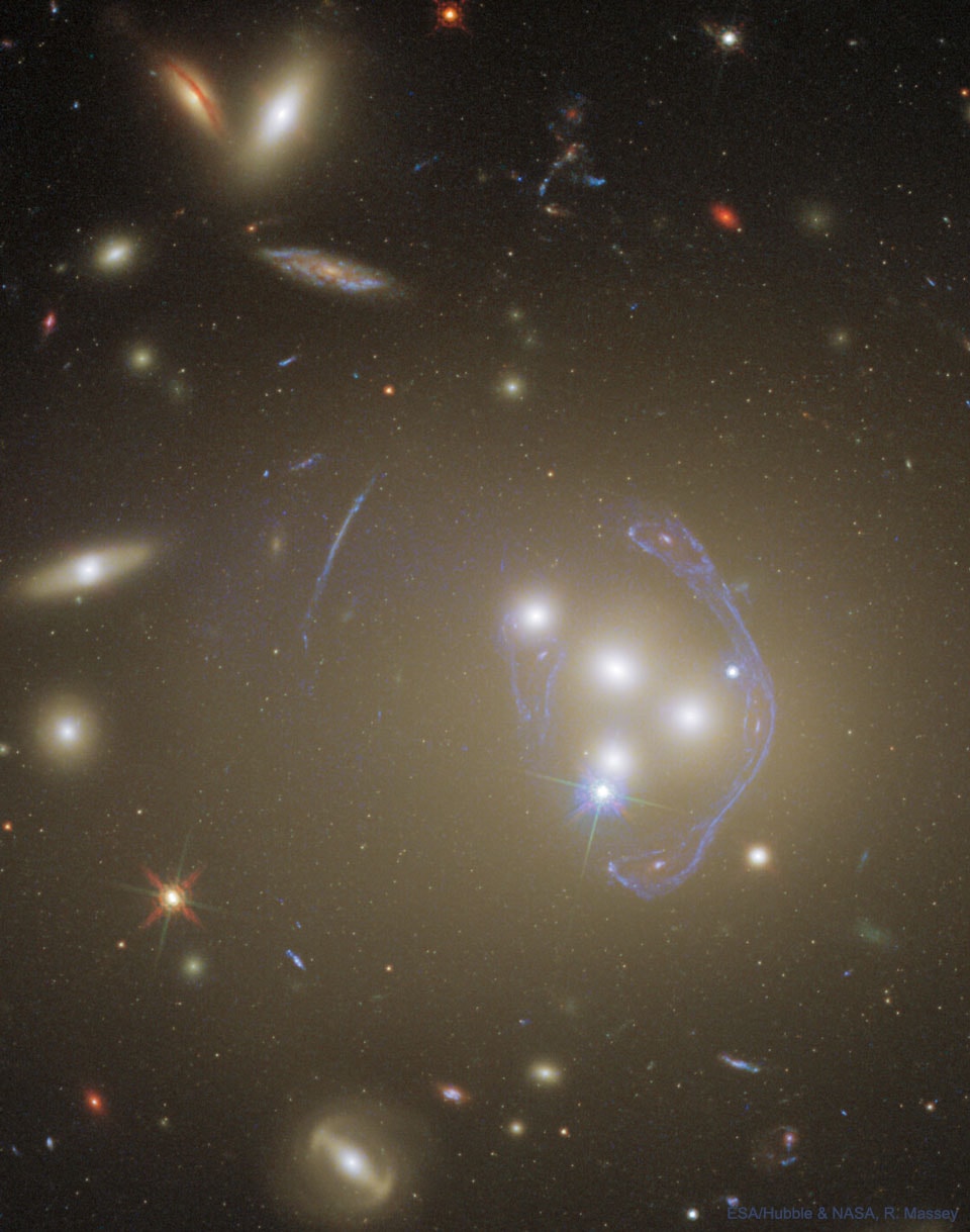 Is that one galaxy or three? Toward the right of the featured Hubble image of the massive galaxy cluster Abell 3827 is what appears to be a most unusual galaxy -- curved and with three centers. A detailed analysis, however, finds that these are three images of the same background galaxy -- and that there are at least four more images. Light we see from the single background blue galaxy takes multiple paths through the complex gravity of the cluster, just like a single distant light can take multiple paths through the stem of a wine glass. Studying how clusters like Abell 3827 and their component galaxies deflect distant light gives information about how mass and dark matter are distributed. Abell 3827 is so distant, having a redshift of 0.1, that the light we see from it left about 1.3 billion years ago -- before dinosaurs roamed the Earth. Therefore, the cluster's central galaxies have now surely all coalesced -- in a feast of galactic cannibalism -- into one huge galaxy near the cluster's center.