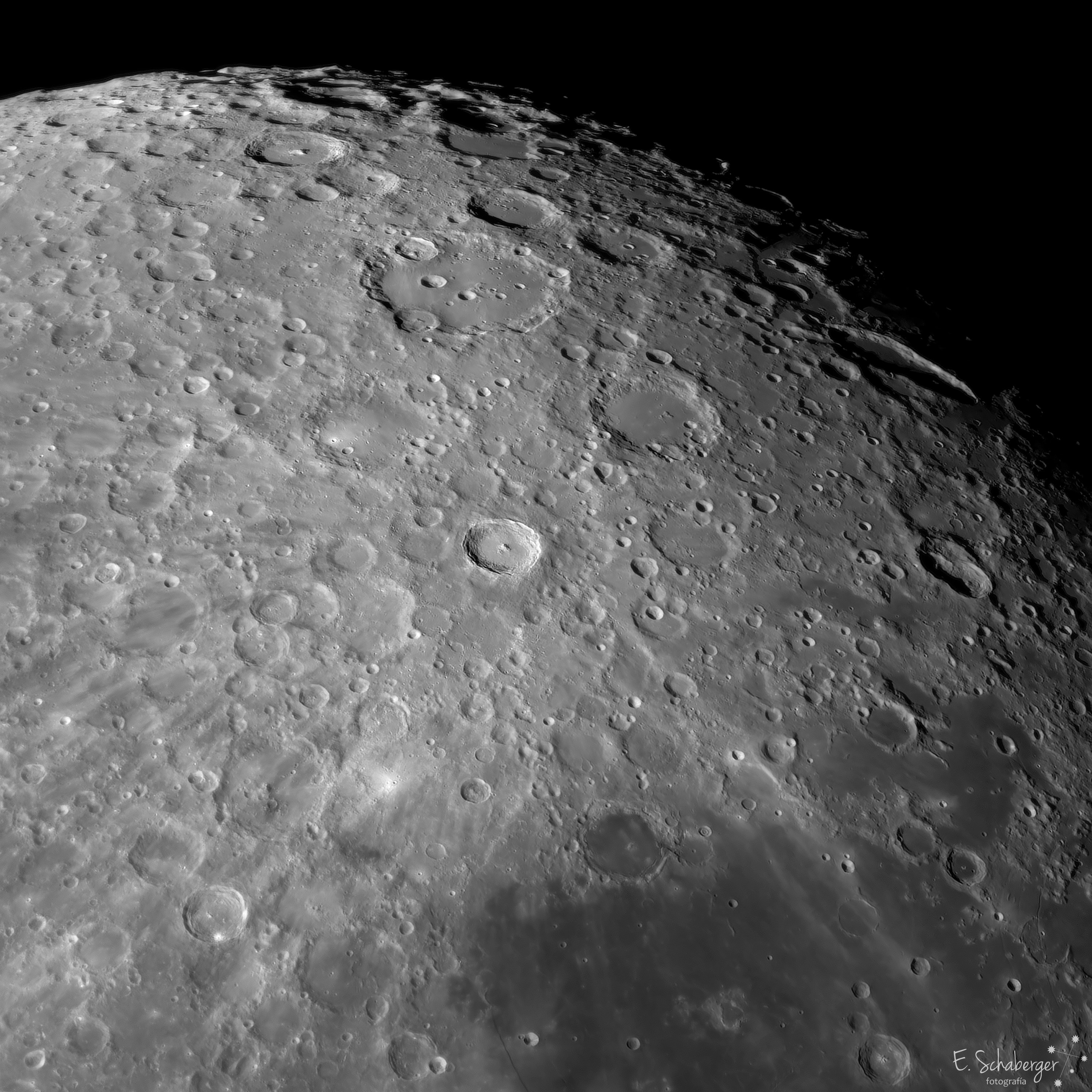 South is up in this detailed telescopic view across the Moon's rugged southern highlands. Captured on July 20, the lunar landscape features the Moon's young and old, the large craters Tycho and Clavius. About 100 million years young, Tycho is the sharp-walled 85 kilometer diameter crater near center, its 2 kilometer tall central peak in bright sunlight and dark shadow. Debris ejected during the impact that created Tycho still make it the stand out lunar crater when the Moon is near full, producing a highly visible radiating system of light streaks, bright rays that extend across much of the lunar near side. In fact, some of the material collected at the Apollo 17 landing site, about 2,000 kilometers away, likely originated from the Tycho impact. One of the oldest and largest craters on the Moon's near side, 225 kilometer diameter Clavius is due south (above) of Tycho. Clavius crater's own ray system resulting from its original impact event would have faded long ago. The old crater's worn walls and smooth floor are now overlayed by smaller craters from impacts that occurred after Clavius was formed. Observations by the Stratospheric Observatory for Infrared Astronomy (SOFIA) published in 2020 found water at Clavius. Of course both young Tycho and old Clavius craters are lunar locations in the science fiction epic 2001: A Space Odyssey.