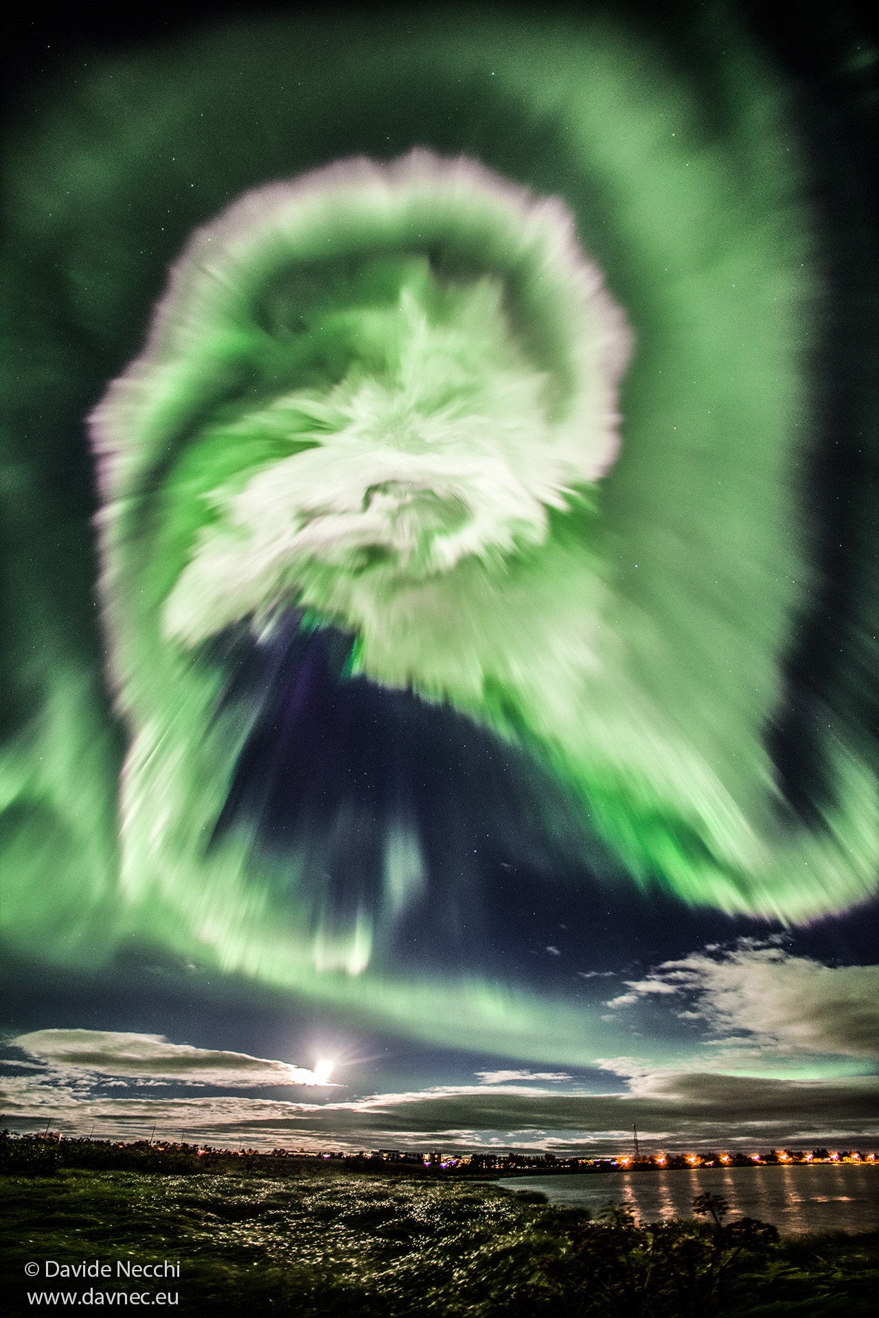 What's happened to the sky? Aurora! Captured in 2015, this aurora was noted by Icelanders for its great brightness and quick development. The aurora resulted from a solar storm, with high energy particles bursting out from the Sun and through a crack in Earth's protective magnetosphere a few days later. Although a spiral pattern can be discerned, creative humans might imagine the complex glow as an atmospheric apparition of any number of common icons. In the foreground of the featured image is the Ölfusá River while the lights illuminate a bridge in Selfoss City. Just beyond the low clouds is a nearly full Moon. The liveliness of the Sun -- and likely the resulting auroras on Earth -- is slowly increasing as the Sun emerges from a Solar minimum, a historically quiet period in its 11-year cycle.