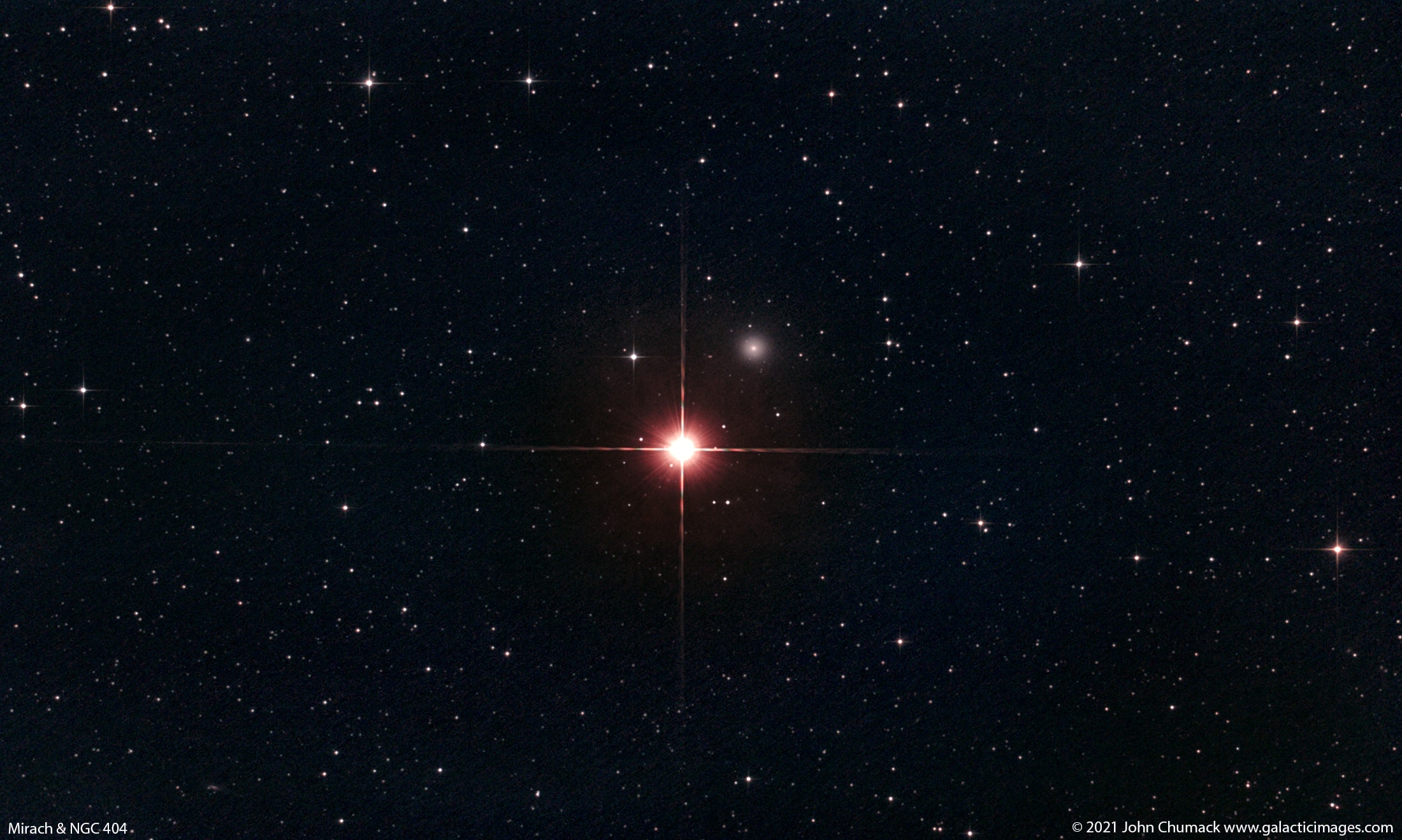 As far as ghosts go, Mirach's Ghost isn't really that scary. Mirach's Ghost is just a faint, fuzzy galaxy, well known to astronomers, that happens to be seen nearly along the line-of-sight to Mirach, a bright star. Centered in this star field, Mirach is also called Beta Andromedae. About 200 light-years distant, Mirach is a red giant star, cooler than the Sun but much larger and so intrinsically much brighter than our parent star. In most telescopic views, glare and diffraction spikes tend to hide things that lie near Mirach and make the faint, fuzzy galaxy look like a ghostly internal reflection of the almost overwhelming starlight. Still, appearing in this sharp image just above and to the right of Mirach, Mirach's Ghost is cataloged as galaxy NGC 404 and is estimated to be some 10 million light-years away.