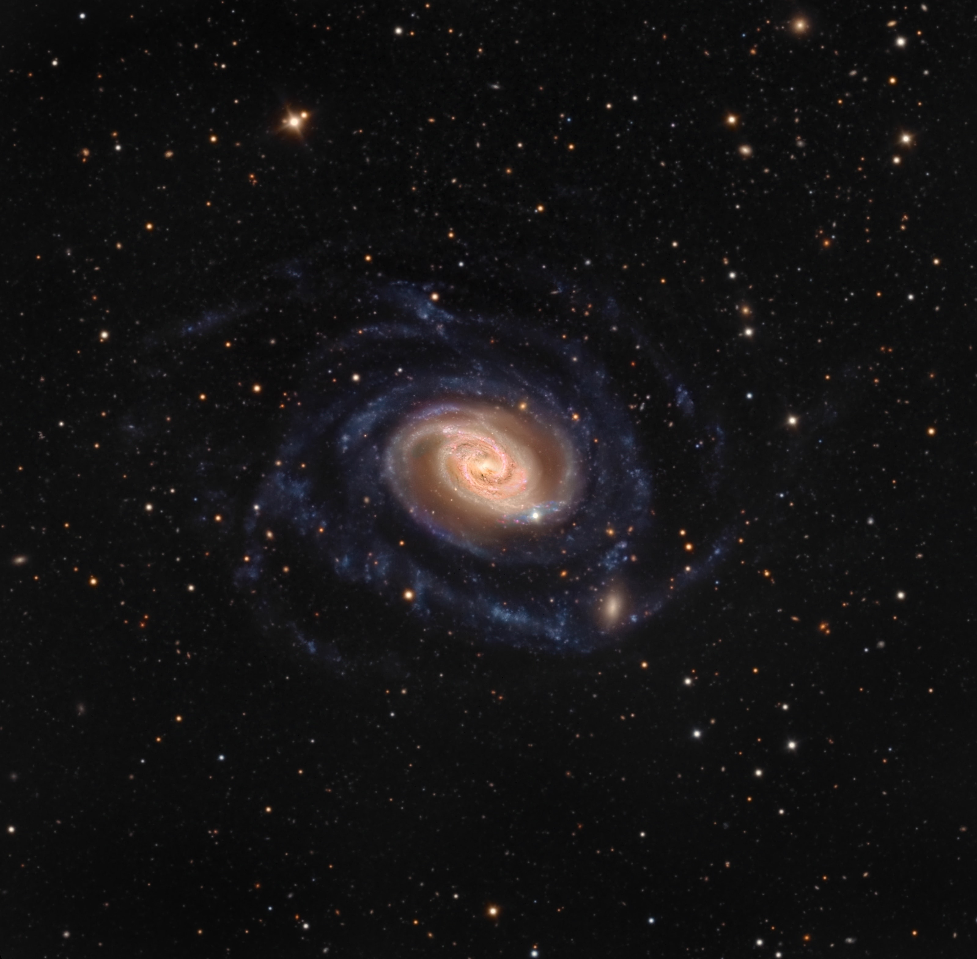 About 70 million light-years distant, gorgeous spiral galaxy NGC 289 is larger than our own Milky Way. Seen nearly face-on, its bright core and colorful central disk give way to remarkably faint, bluish spiral arms. The extensive arms sweep well over 100 thousand light-years from the galaxy's center. At the lower right in this sharp, telescopic galaxy portrait the main spiral arm seems to encounter a small, fuzzy elliptical companion galaxy interacting with enormous NGC 289. Of course spiky stars are in the foreground of the scene. They lie within the Milky Way toward the southern constellation Sculptor.
