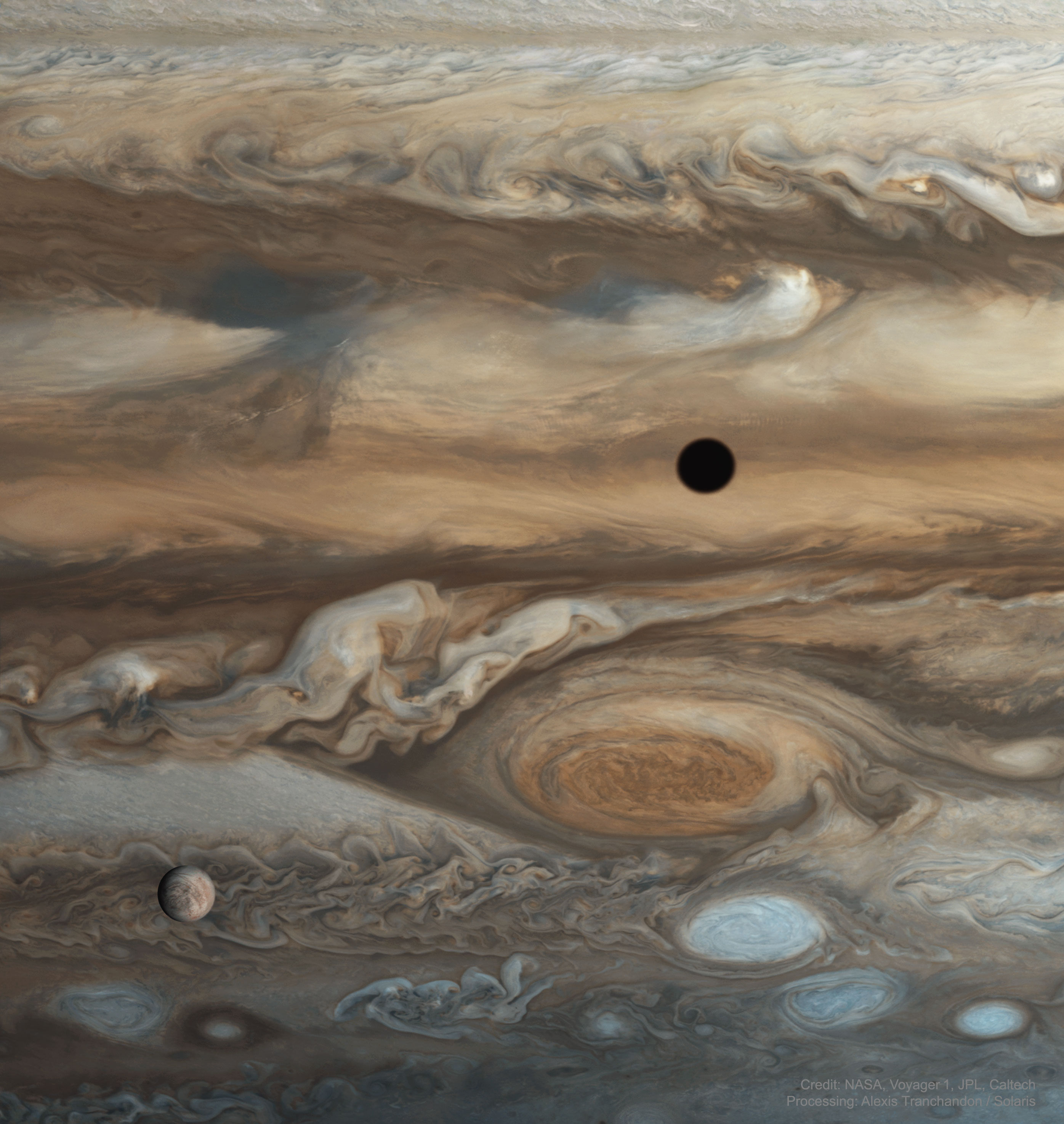 What are those spots on Jupiter? Largest and furthest, just right of center, is the Great Red Spot -- a huge storm system that has been raging on Jupiter possibly since Giovanni Cassini's likely notation of it 357 years ago. It is not yet known why this Great Spot is red. The spot toward the lower left is one of Jupiter's largest moons: Europa. Images from Voyager in 1979 bolster the modern hypothesis that Europa has an underground ocean and is therefore a good place to look for extraterrestrial life. But what about the dark spot on the upper right? That is a shadow of another of Jupiter's large moons: Io. Voyager 1 discovered Io to be so volcanic that no impact craters could be found. Sixteen frames from Voyager 1's flyby of Jupiter in 1979 were recently reprocessed and merged to create the featured image. Forty-five years ago this September, Voyager 1 launched from Earth and started one of the greatest explorations of the Solar System ever. Free Download: Voyager Posters