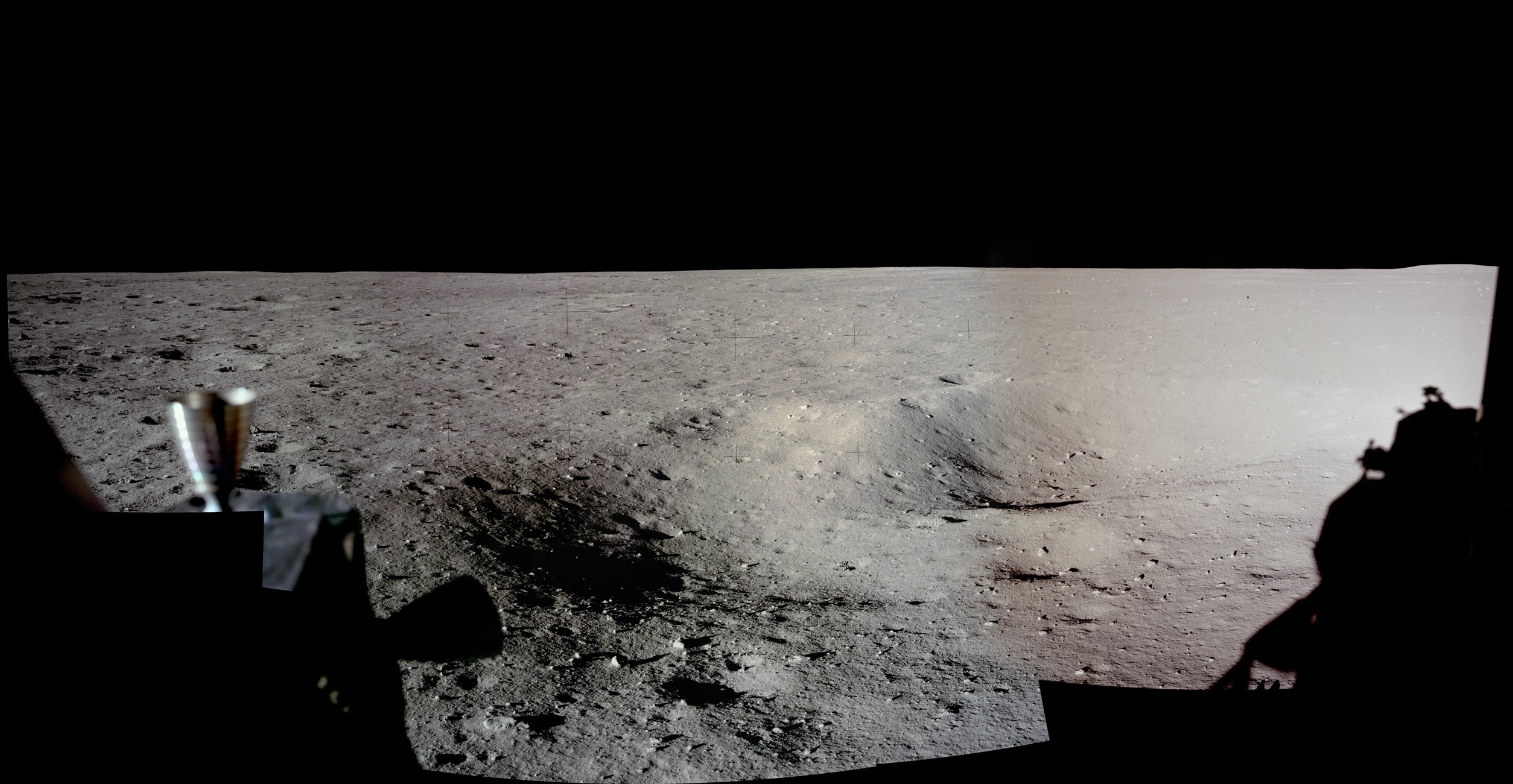 Have you seen a panorama from another world lately? Assembled from high-resolution scans of the original film frames, this one sweeps across the magnificent desolation of the Apollo 11 landing site on the Moon's Sea of Tranquility. The images were taken by Neil Armstrong looking out his window of the Eagle Lunar Module shortly after the July 20, 1969 landing. The frame at the far left (AS11-37-5449) is the first picture taken by a person on another world. Toward the south, thruster nozzles can be seen in the foreground on the left, while at the right, the shadow of the Eagle is visible to the west. For scale, the large, shallow crater on the right has a diameter of about 12 meters. Frames taken from the Lunar Module windows about an hour and a half after landing, before walking on the lunar surface, were intended to initially document the landing site in case an early departure was necessary.