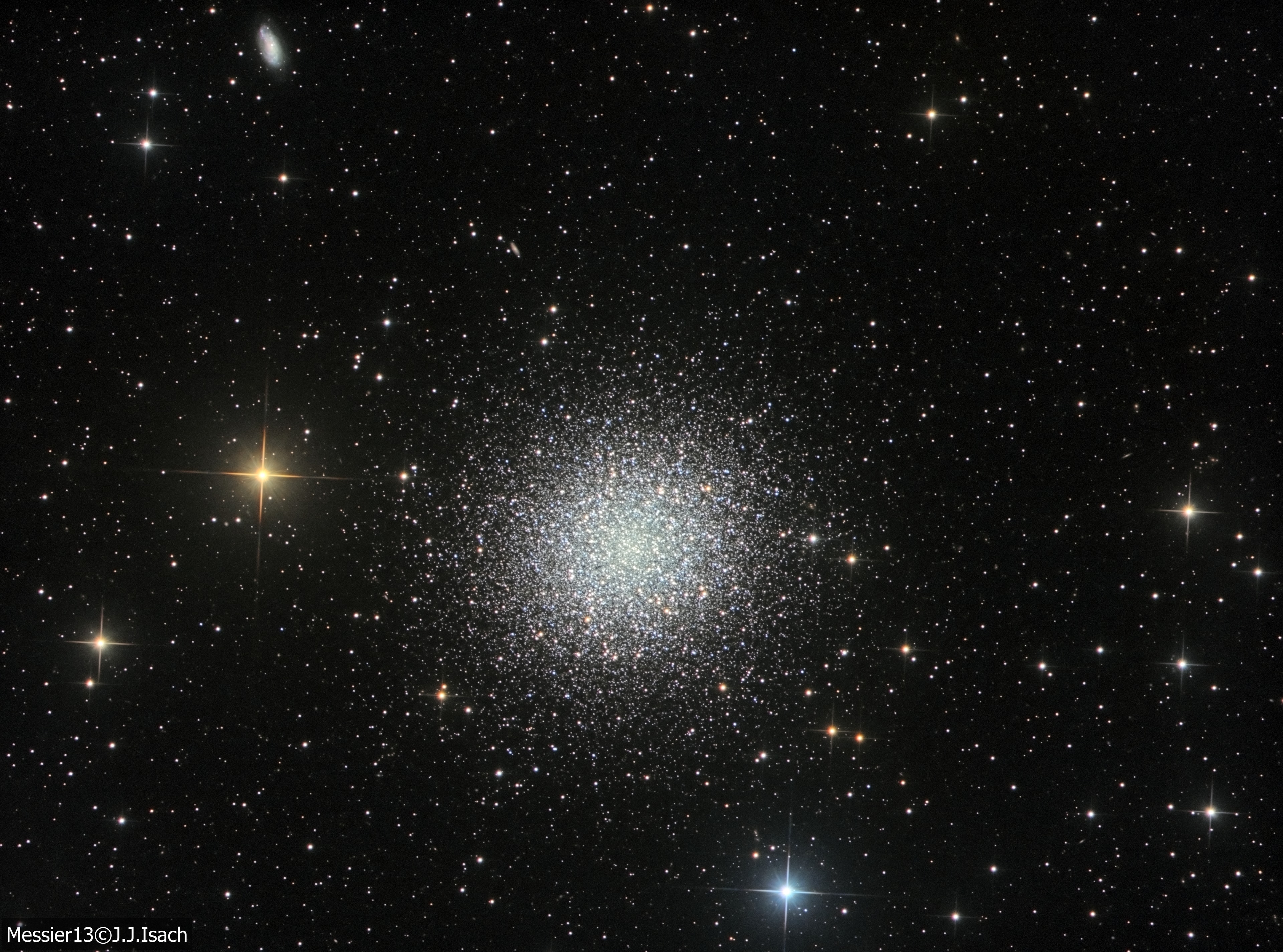 In 1716, English astronomer Edmond Halley noted, "This is but a little Patch, but it shows itself to the naked Eye, when the Sky is serene and the Moon absent." Of course, M13 is now less modestly recognized as the Great Globular Cluster in Hercules, one of the brightest globular star clusters in the northern sky. Sharp telescopic views like this one reveal the spectacular cluster's hundreds of thousands of stars. At a distance of 25,000 light-years, the cluster stars crowd into a region 150 light-years in diameter. Approaching the cluster core upwards of 100 stars could be contained in a cube just 3 light-years on a side. For comparison, the closest star to the Sun is over 4 light-years away. The remarkable range of brightness recorded in this image follows stars into the dense cluster core. Distant background galaxies in the medium-wide field of view include NGC 6207 at the upper left.