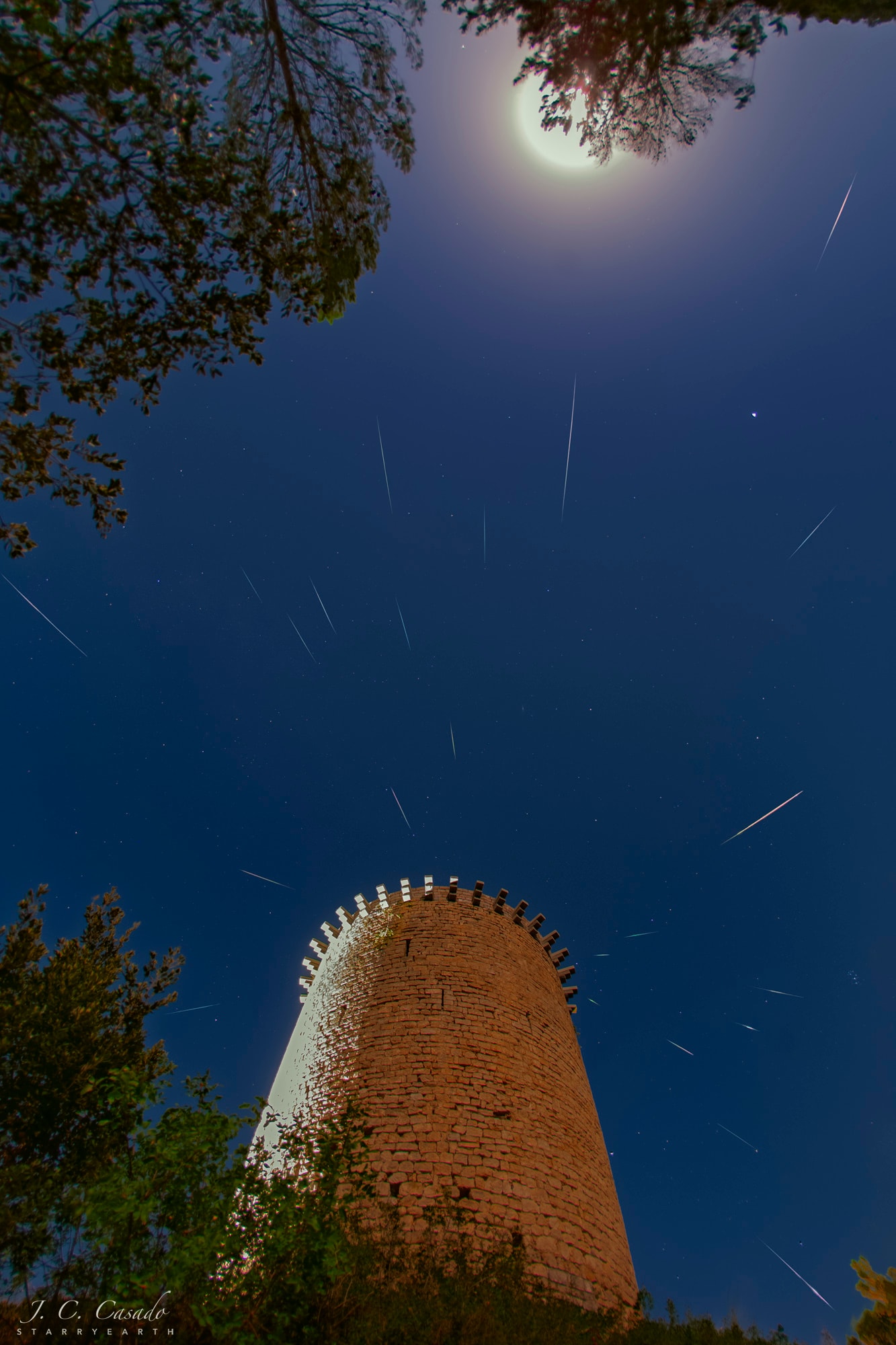 The annual Perseid meteor shower was near its peak on August 13. As planet Earth crossed through streams of debris left by periodic Comet Swift-Tuttle meteors rained in northern summer night skies. But even that night's nearly Full Moon shining near the top of this composited view couldn't hide all of the popular shower's meteor streaks. The image captures some of the brightest perseid meteors in many short exposures recorded over more than two hours before the dawn. It places the shower's radiant in the heroic constellation of Perseus just behind a well-lit medieval tower in the village of Sant Llorenc de la Muga, Girona, Spain. Observed in medieval times, the Perseid meteor shower is also known in Catholic tradition as the Tears of St. Lawrence, and festivities are celebrated close to the annual peak of the meteor shower. Joining the Full Moon opposite the Sun, bright planet Saturn also shines in the frame at the upper right.