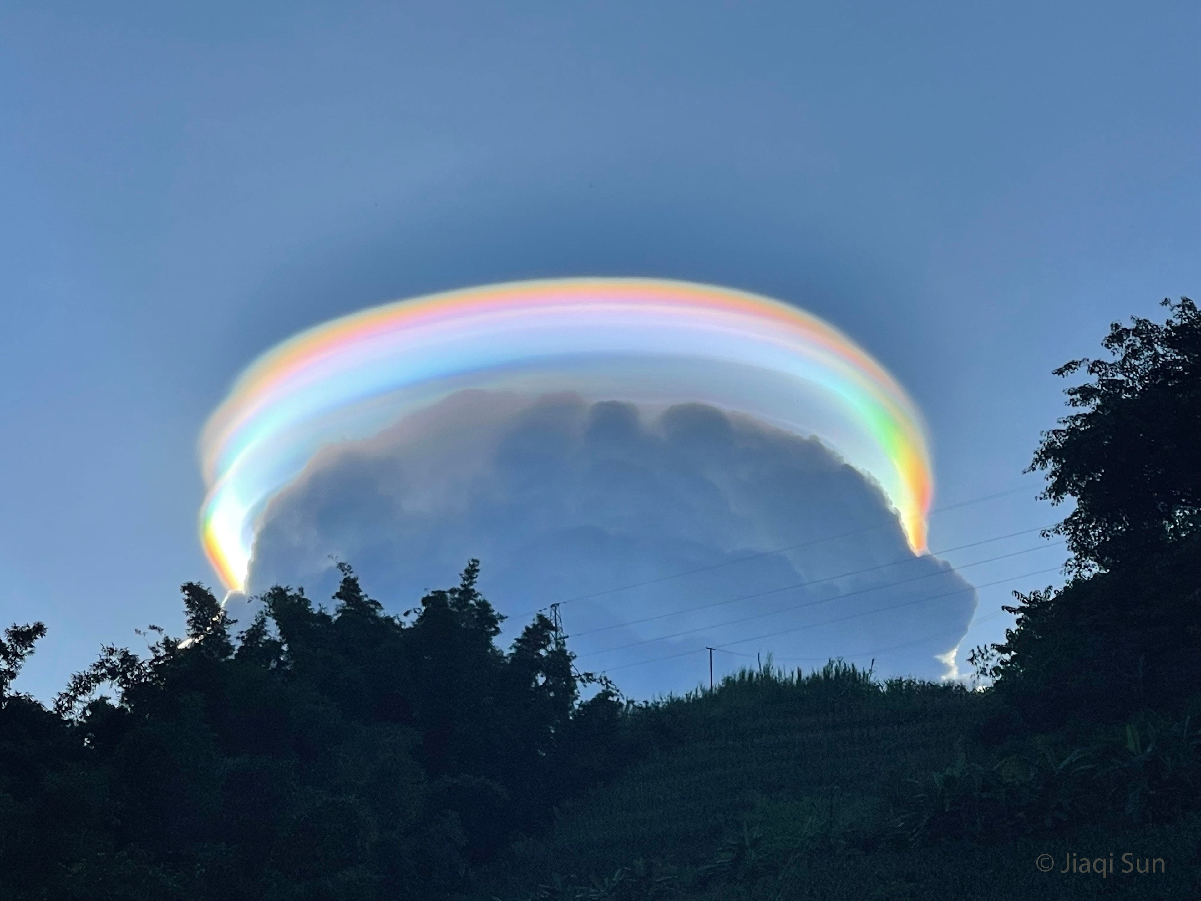 Yes, but how many dark clouds have a multicolored lining? Pictured, behind this darker cloud, is a pileus iridescent cloud, a group of water droplets that have a uniformly similar size and so together diffract different colors of sunlight by different amounts. The featured image was taken last month in Pu'er, Yunnan Province, China. Also captured were unusual cloud ripples above the pileus cloud. The formation of a rare pileus cloud capping a common cumulus cloud is an indication that the lower cloud is expanding upward and might well develop into a storm. Explore Your Universe: Random APOD Generator