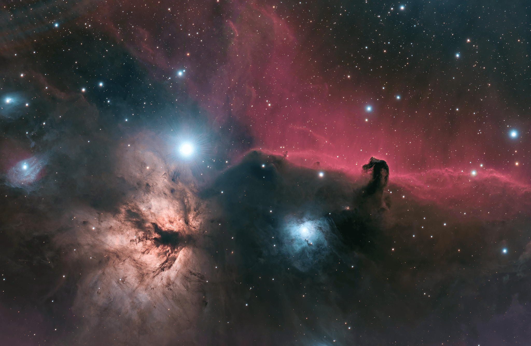 The Horsehead Nebula, famous celestial dark marking also known as Barnard 33, is notched against a background glow of emission nebulae in this sharp cosmic skyscape. About five light-years "tall" the Horsehead lies some 1,500 light-years away in the constellation of Orion. Within the region's fertile molecular cloud complex, the expanse of obscuring dust has a recognizable shape only by chance from our perspective in the Milky Way though. Orion's easternmost belt star, bright Alnitak, is to the left of center. Energetic ultraviolet light from Alnitak powers the glow of dusty NGC 2024, the Flame Nebula, just below it. Completing a study in cosmic contrasts, bluish reflection nebula NGC 2023 is below the Horsehead itself. This well-framed telescopic field spans about 3 full moons on the sky.