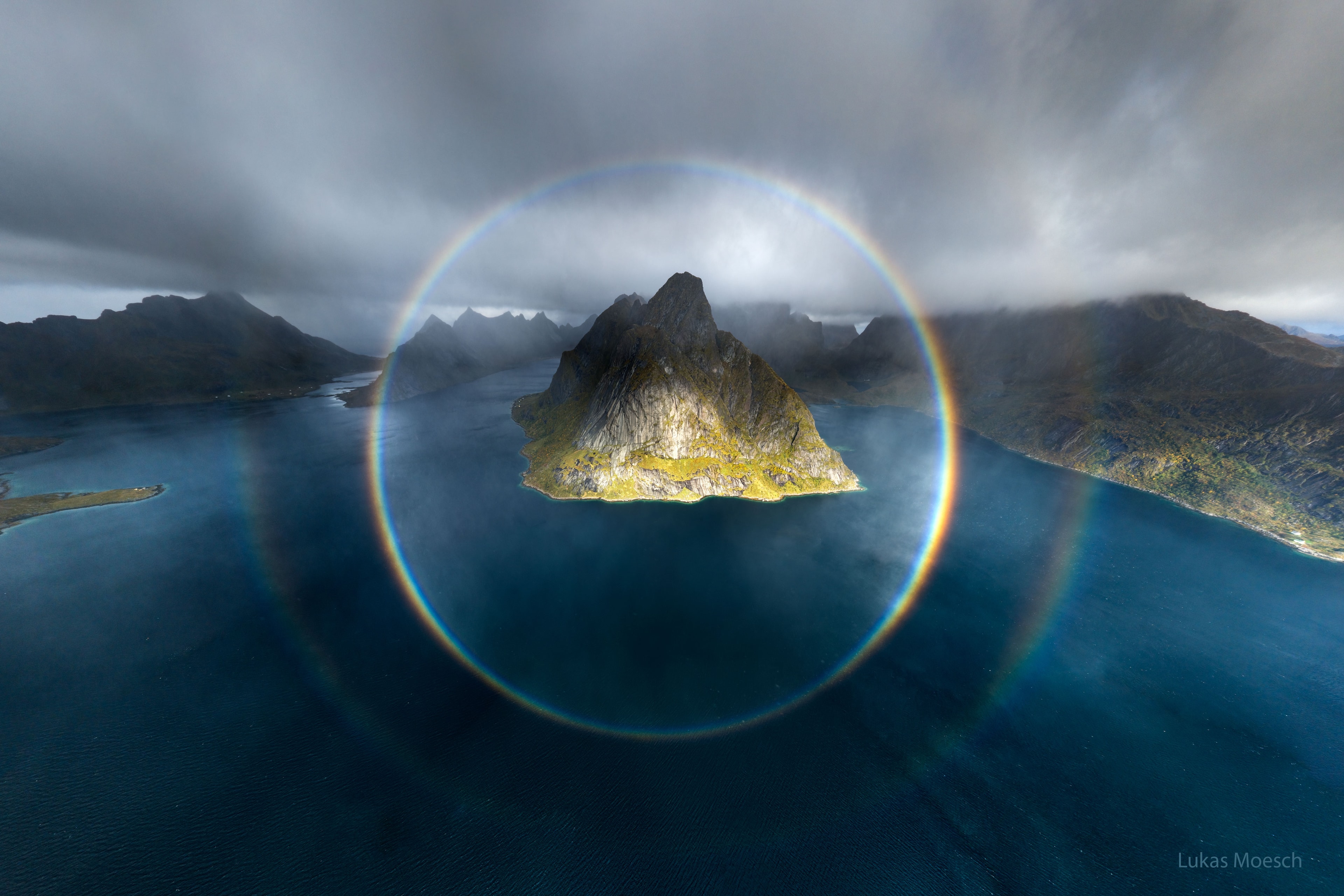 Have you ever seen an entire rainbow? From the ground, typically, only the top portion of a rainbow is visible because directions toward the ground have fewer raindrops. From the air, though, the entire 360-degree circle of a rainbow is more commonly visible. Pictured here, a full-circle rainbow was captured over the Lofoten Islands of Norway in September by a drone passing through a rain shower. An observer-dependent phenomenon primarily caused by the internal reflection of sunlight by raindrops, the rainbow has a full diameter of 84 degrees. The Sun is in the exact opposite direction from the rainbow's center. As a bonus, a second rainbow that was more faint and color-reversed was visible outside the first.