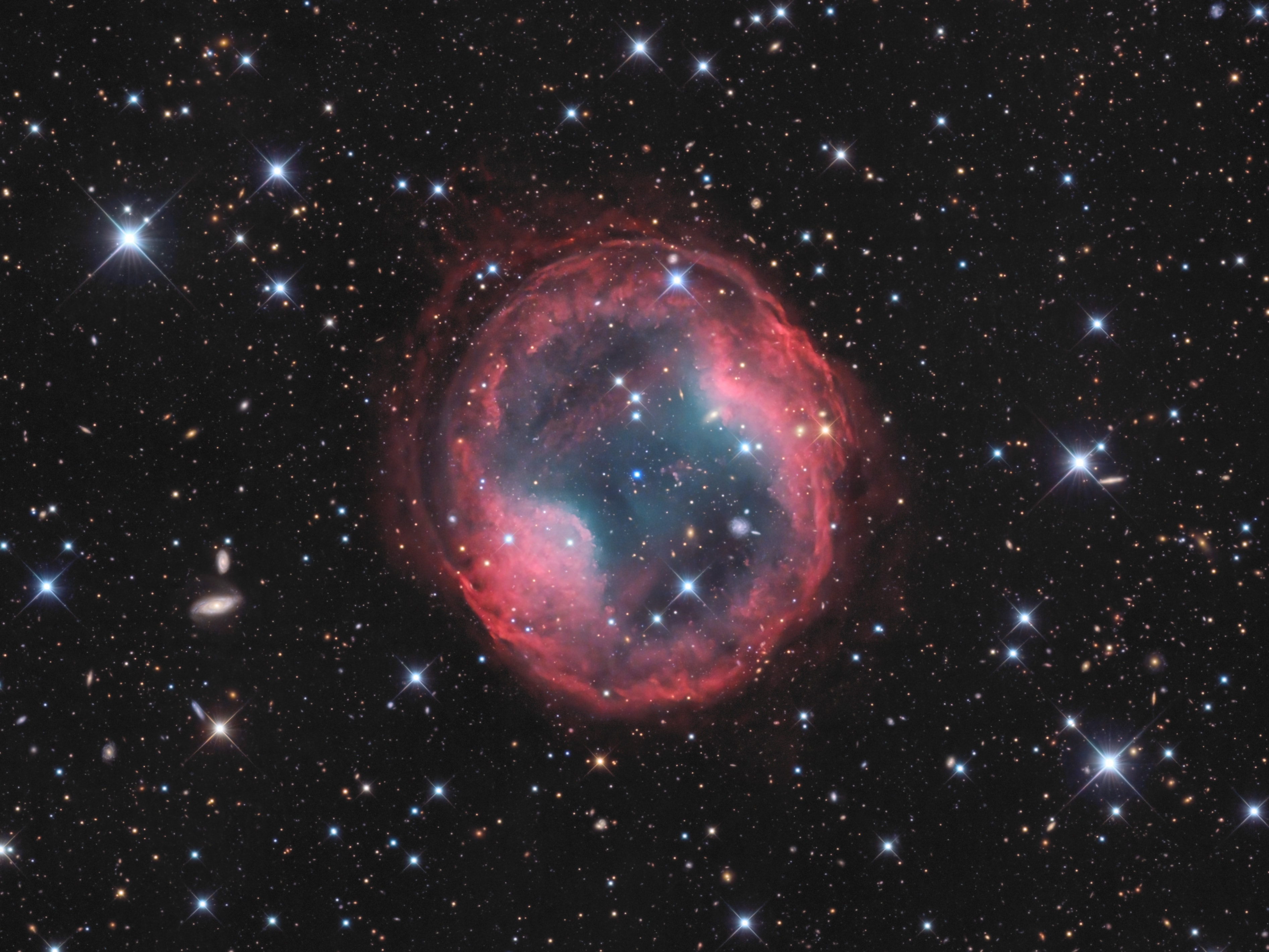 Planetary nebula Jones-Emberson 1 is the death shroud of a dying Sun-like star. It lies some 1,600 light-years from Earth toward the sharp-eyed constellation Lynx. About 4 light-years across, the expanding remnant of the dying star's atmosphere was shrugged off into interstellar space, as the star's central supply of hydrogen and then helium for fusion was finally depleted after billions of years. Visible near the center of the planetary nebula is what remains of the stellar core, a blue-hot white dwarf star. Also known as PK 164 +31.1, the nebula is faint and very difficult to glimpse at a telescope's eyepiece. But this deep broadband image combining 22 hours of exposure time does show it off in exceptional detail. Stars within our own Milky Way galaxy as well as background galaxies across the universe are scattered through the clear field of view. Ephemeral on the cosmic stage, Jones-Emberson 1 will fade away over the next few thousand years. Its hot, central white dwarf star will take billions of years to cool.