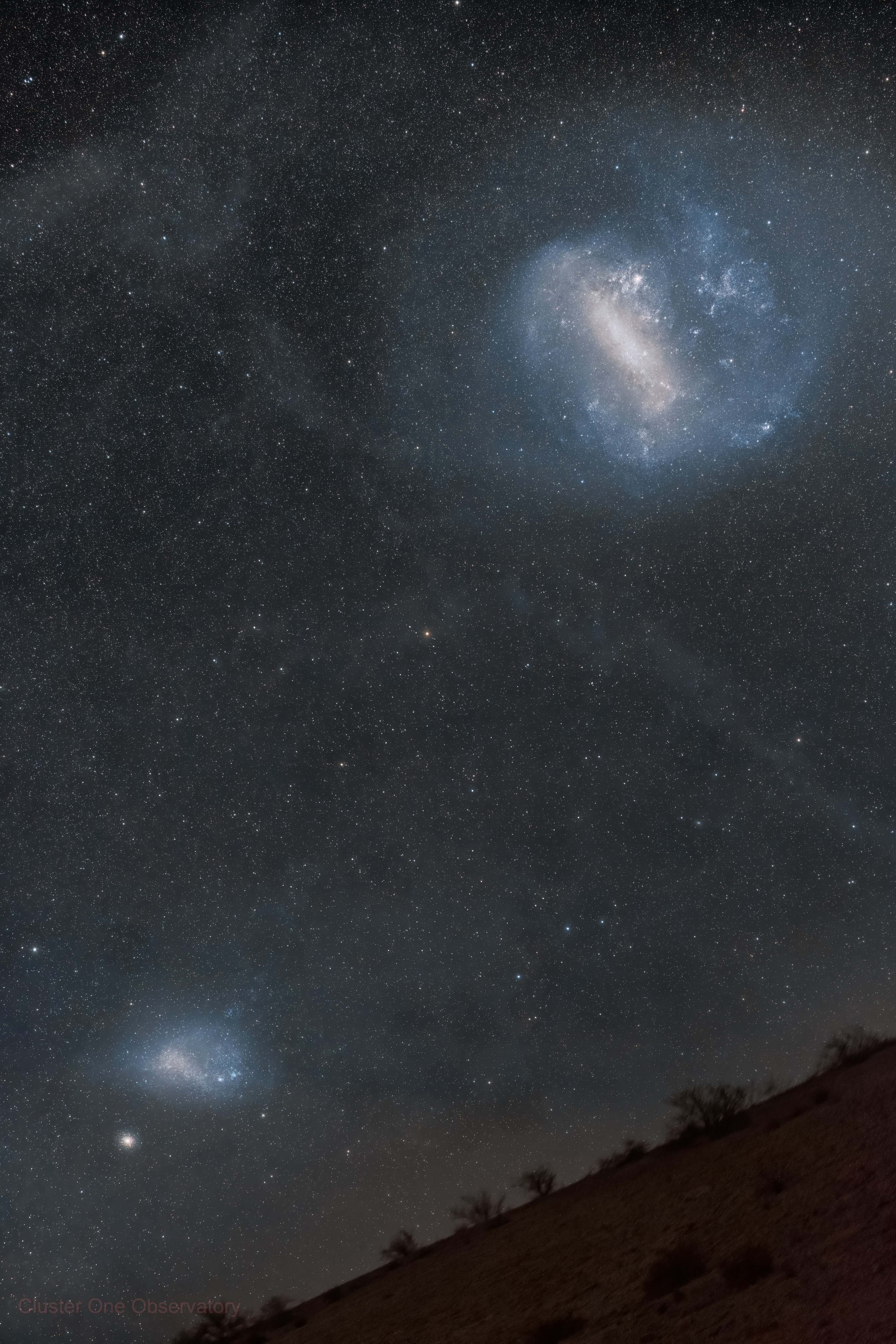 The two prominent clouds in this Chilean Atacama Desert skyscape captured on January 21 actually lie beyond our Milky Way galaxy. Known as the Large and the Small Magellanic Clouds they are so named for the 16th century Portuguese explorer Ferdinand Magellan, leader of the first circumnavigation of planet Earth. Famous jewels of southern hemisphere skies, they are the brightest satellite galaxies of the Milky Way. The larger cloud is some 160,000 light-years, and the smaller 210,000 light-years distant. While both are irregular dwarf galaxies in their own right, they exhibit central barred structures in the deep wide-angle view. Wide and deep exposures also reveal faint dusty galactic cirrus nebulae and the imprints of gravitational tidal interactions between the Large and Small Magellanic Clouds.