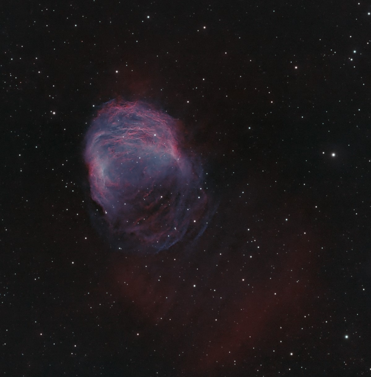 Braided and serpentine filaments of glowing gas suggest this nebula's popular name, The Medusa Nebula. Also known as Abell 21, this Medusa is an old planetary nebula some 1,500 light-years away in the constellation Gemini. Like its mythological namesake, the nebula is associated with a dramatic transformation. The planetary nebula phase represents a final stage in the evolution of low mass stars like the sun as they transform themselves from red giants to hot white dwarf stars and in the process shrug off their outer layers. Ultraviolet radiation from the hot star powers the nebular glow. The Medusa's transforming star is the faint one near the center of the overall bright crescent shape. In this deep telescopic view, fainter filaments clearly extend below and right of the bright crescent region. The Medusa Nebula is estimated to be over 4 light-years across.