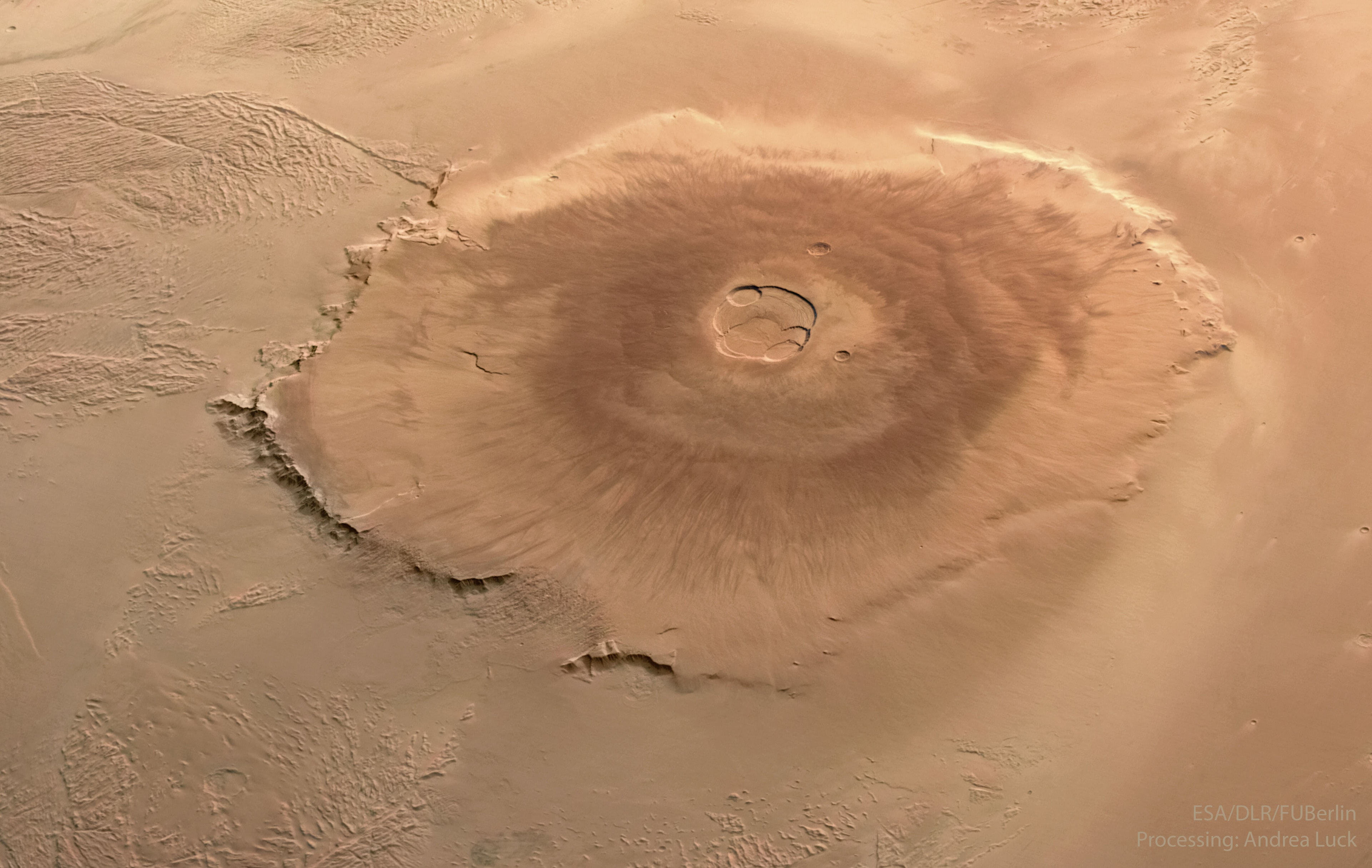The largest volcano in our Solar System is on Mars. Although three times higher than Earth's Mount Everest, Olympus Mons will not be difficult for humans to climb because of the volcano's shallow slopes and Mars' low gravity. Covering an area greater than the entire Hawaiian volcano chain, the slopes of Olympus Mons typically rise only a few degrees at a time. Olympus Mons is an immense shield volcano, built long ago by fluid lava. A relatively static surface crust allowed it to build up over time. Its last eruption is thought to have been about 25 million years ago. The featured image was taken by the European Space Agency's robotic Mars Express spacecraft currently orbiting the Red Planet. Your Sky Surprise: What picture did APOD feature on your birthday? (post 1995)