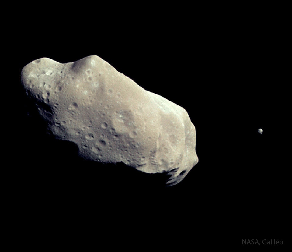This asteroid has a moon. The robot spacecraft Galileo on route to Jupiter in 1993 encountered and photographed two asteroids during its long interplanetary voyage. The second minor planet it photographed, 243 Ida, was unexpectedly discovered to have a moon. The tiny moon, Dactyl, is only about 1.6 kilometers across and seen as a small dot on the right of the sharpened featured image. In contrast, the potato-shaped Ida is much larger, measuring about 60 kilometers long and 25 km wide. Dactyl is the first moon of an asteroid ever discovered -- now many asteroids are known to have moons. The names Ida and Dactyl are from Greek mythology.