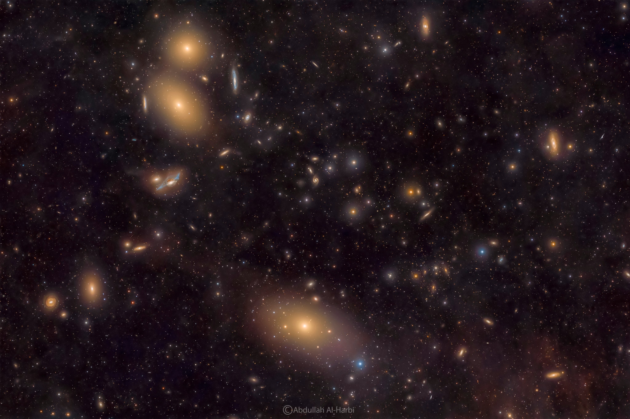 Galaxies of the Virgo Cluster are scattered across this nearly 4 degree wide telescopic field of view. About 50 million light-years distant, the Virgo Cluster is the closest large galaxy cluster to our own local galaxy group. Prominent here are Virgo's bright elliptical galaxies Messier catalog, M87 at bottom center, and M84 and M86 (top to bottom) near top left. M84 and M86 are recognized as part of Markarian's Chain, a visually striking line-up of galaxies on the left side of this frame. Near the middle of the chain lies an intriguing interacting pair of galaxies, NGC 4438 and NGC 4435, known to some as Markarian's Eyes. Of course giant elliptical galaxy M87 dominates the Virgo cluster. It's the home of a super massive black hole, the first black hole ever imaged by planet Earth's Event Horizon Telescope.