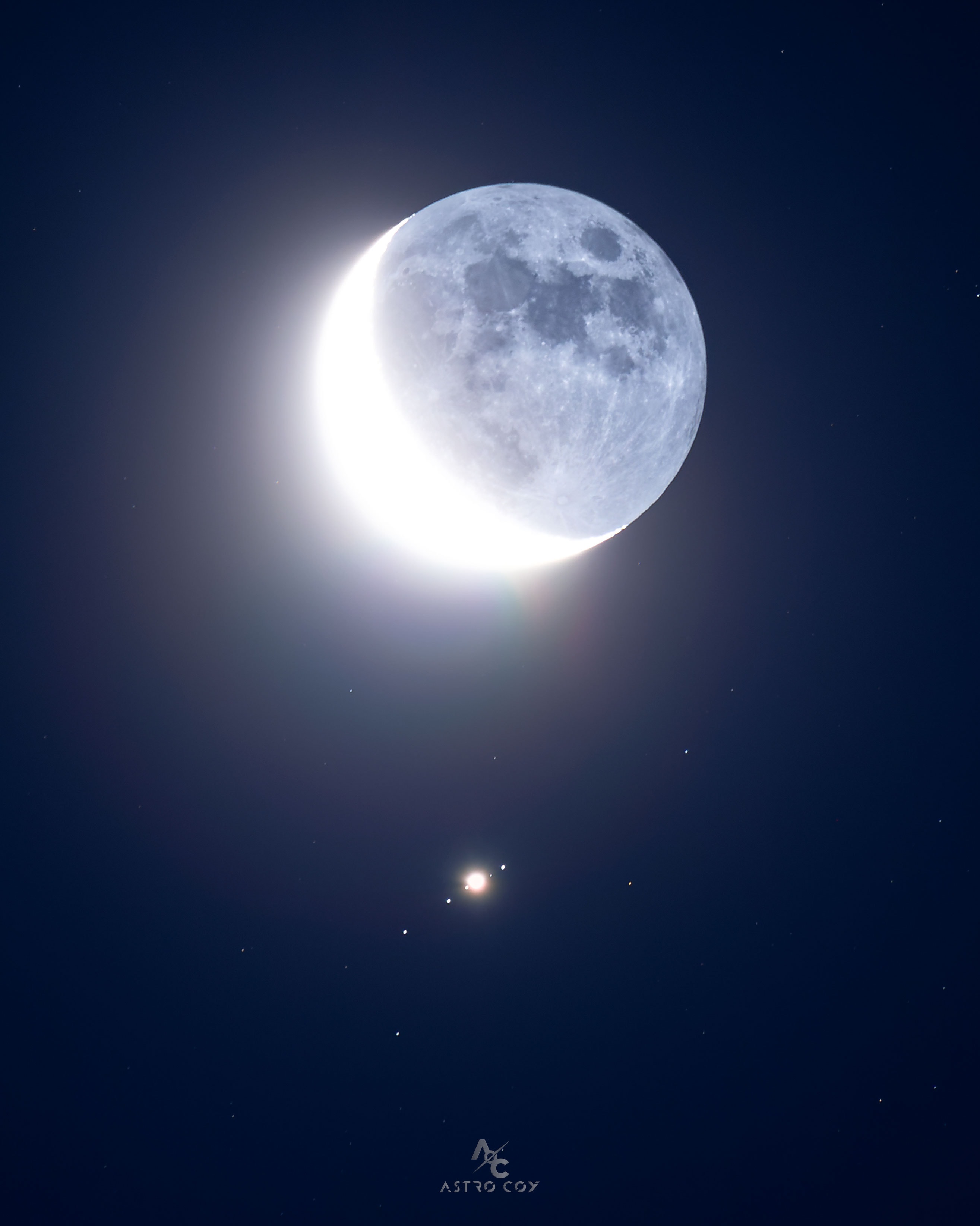 What's that below the Moon? Jupiter -- and its largest moons. Many skygazers across planet Earth enjoyed the close conjunction of Earth's Moon passing nearly in front of Jupiter in mid-June. The featured image is a single exposure of the event taken from Morón de la Frontera, Spain. The sunlit lunar crescent on the left is overexposed, while the Moon's night side, on the right, is only faintly illuminated by Earthshine. Lined up diagonally below the Moon, left to right, are Jupiter's bright Galilean satellites: Callisto, Ganymede, Io (hard to see as it is very near to Jupiter), and Europa. In fact, Callisto, Ganymede, and Io are larger than Earth's Moon, while Europa is only slightly smaller. NASA's robotic spacecraft Juno is currently orbiting Jupiter and made a close pass near Io only a week ago. If you look up in the night sky tonight, you will again see two of the brightest objects angularly close together -- because tonight is another Moon-Jupiter conjunction.