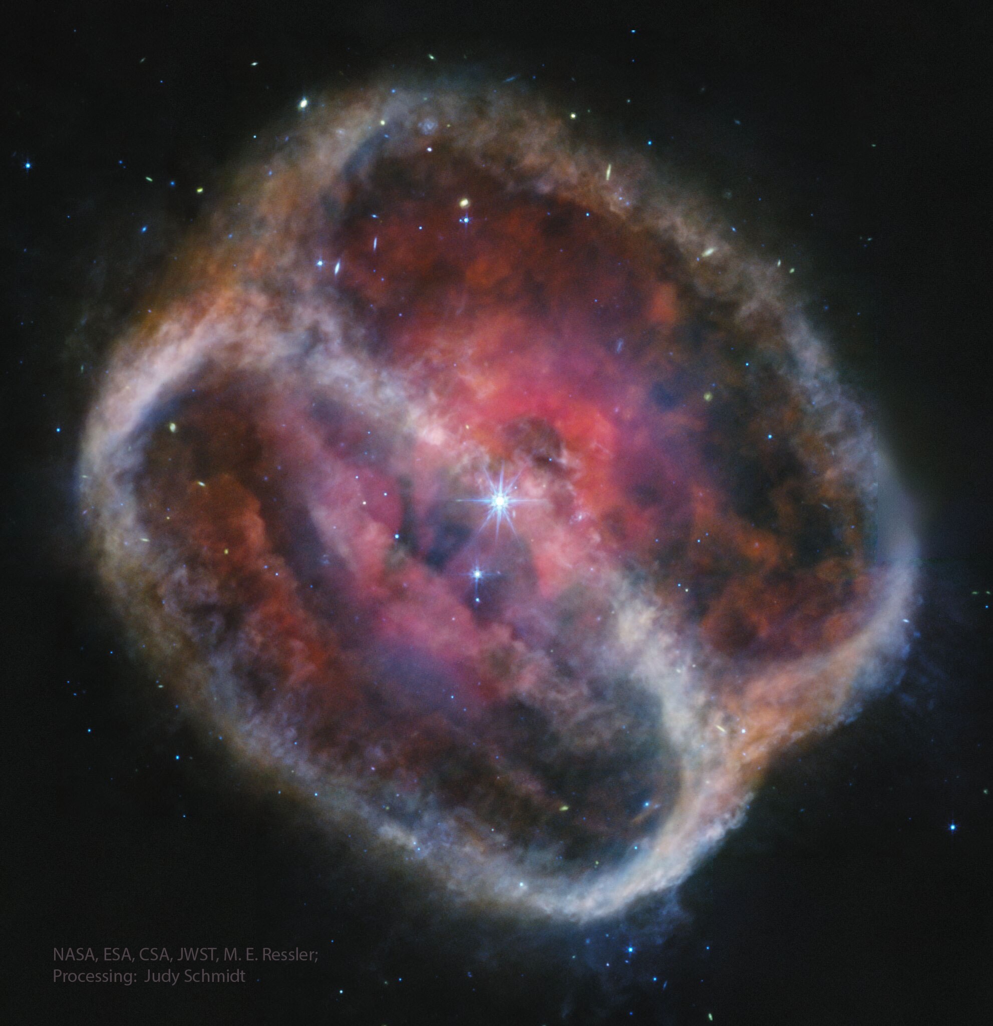 What happens when a star runs out of nuclear fuel? For stars like our Sun, the center condenses into a white dwarf while the outer atmosphere is expelled into space to appear as a planetary nebula. The expelled outer atmosphere of planetary nebula NGC 1514 appears to be a jumble of bubbles -- when seen in visible light. But the view from the James Webb Space Telescope in infrared, as featured here, confirms a different story: in this light the nebula shows a distinct hourglass shape, which is interpreted as a cylinder seen along a diagonal. If you look closely at the center of the nebula, you can also see a bright central star that is part of a binary system. More observations might better reveal how this nebula is evolving and how the central stars are working together to produce the interesting cylinder and bubbles observed. Jump Around the Universe: Random APOD Generator